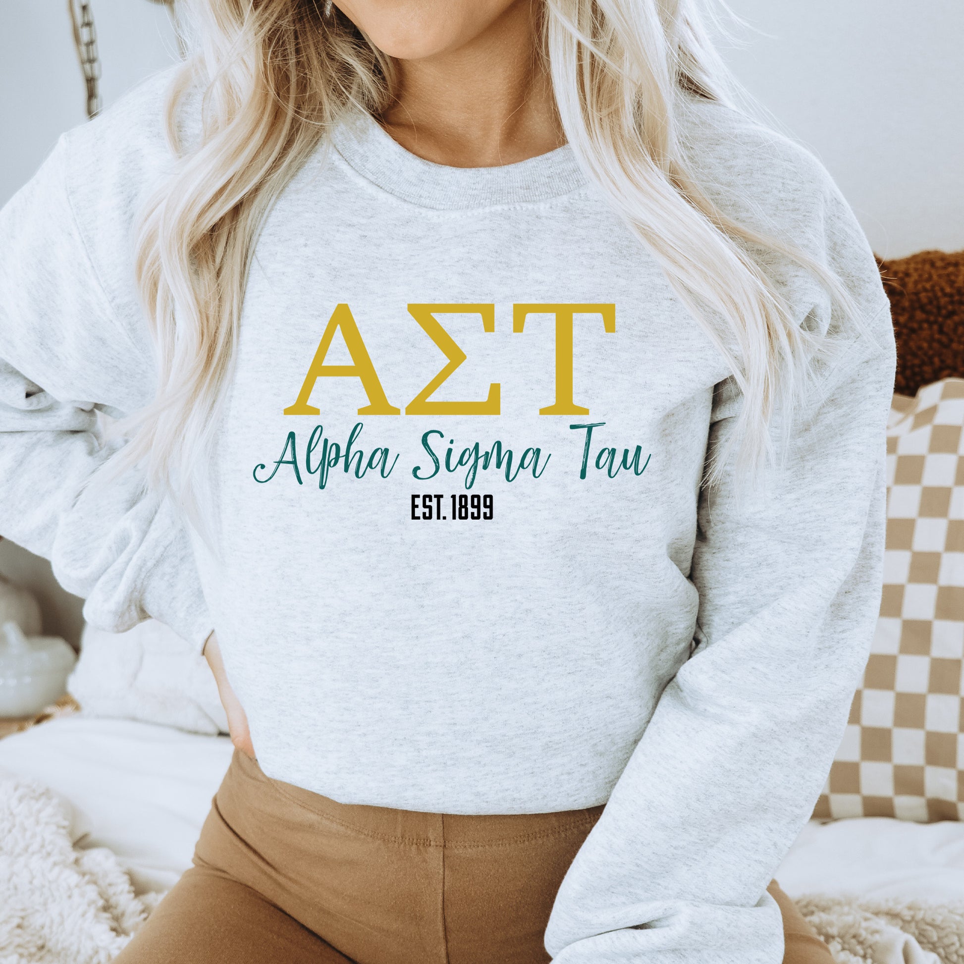 a woman wearing a white sweatshirt with the words ast on it