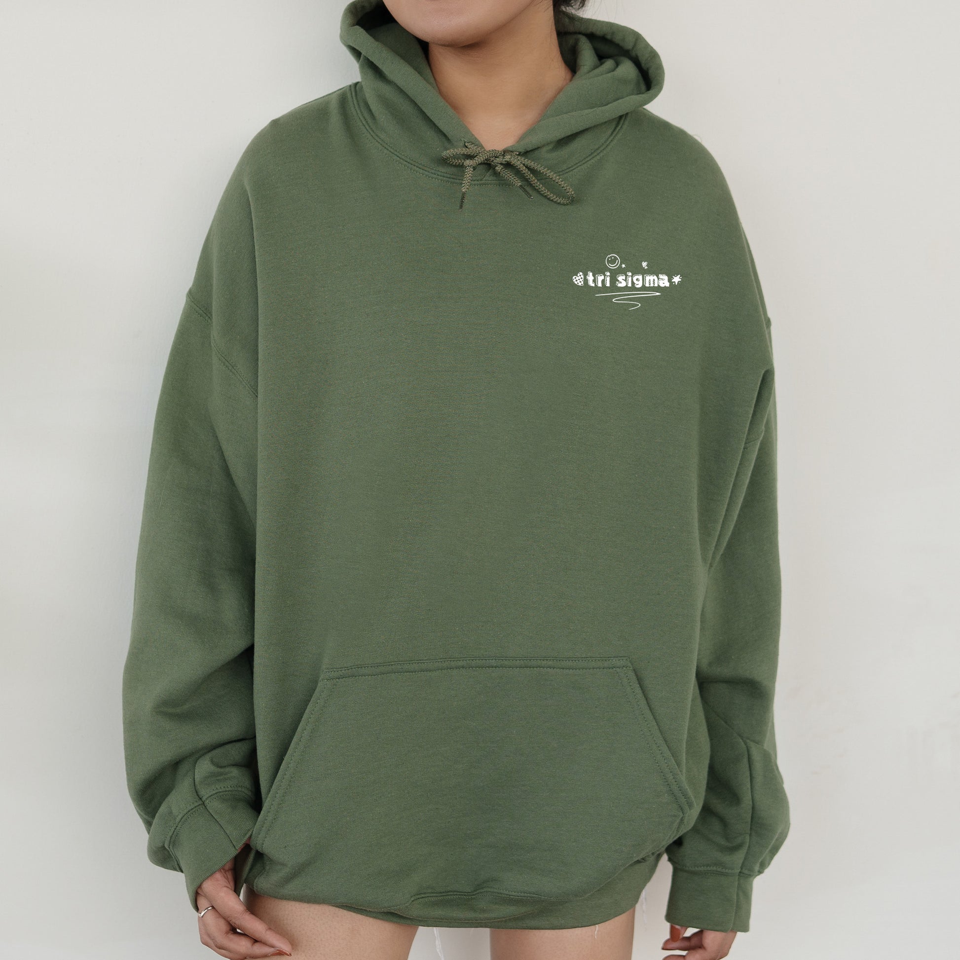 a person wearing a green hoodie with a white logo on it