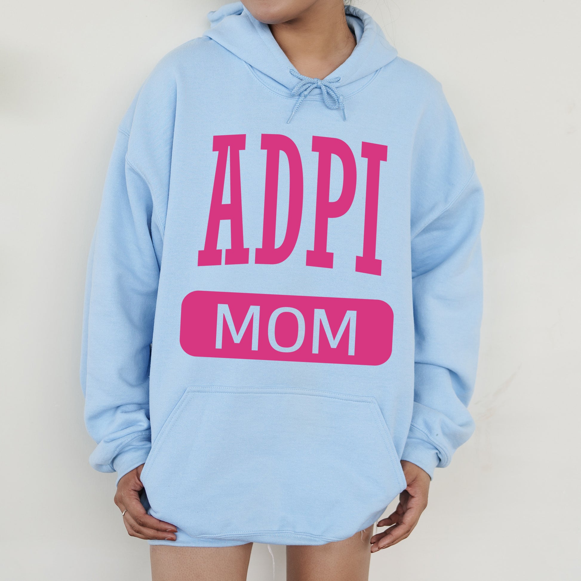 a woman wearing a blue hoodie with the words appi mom on it