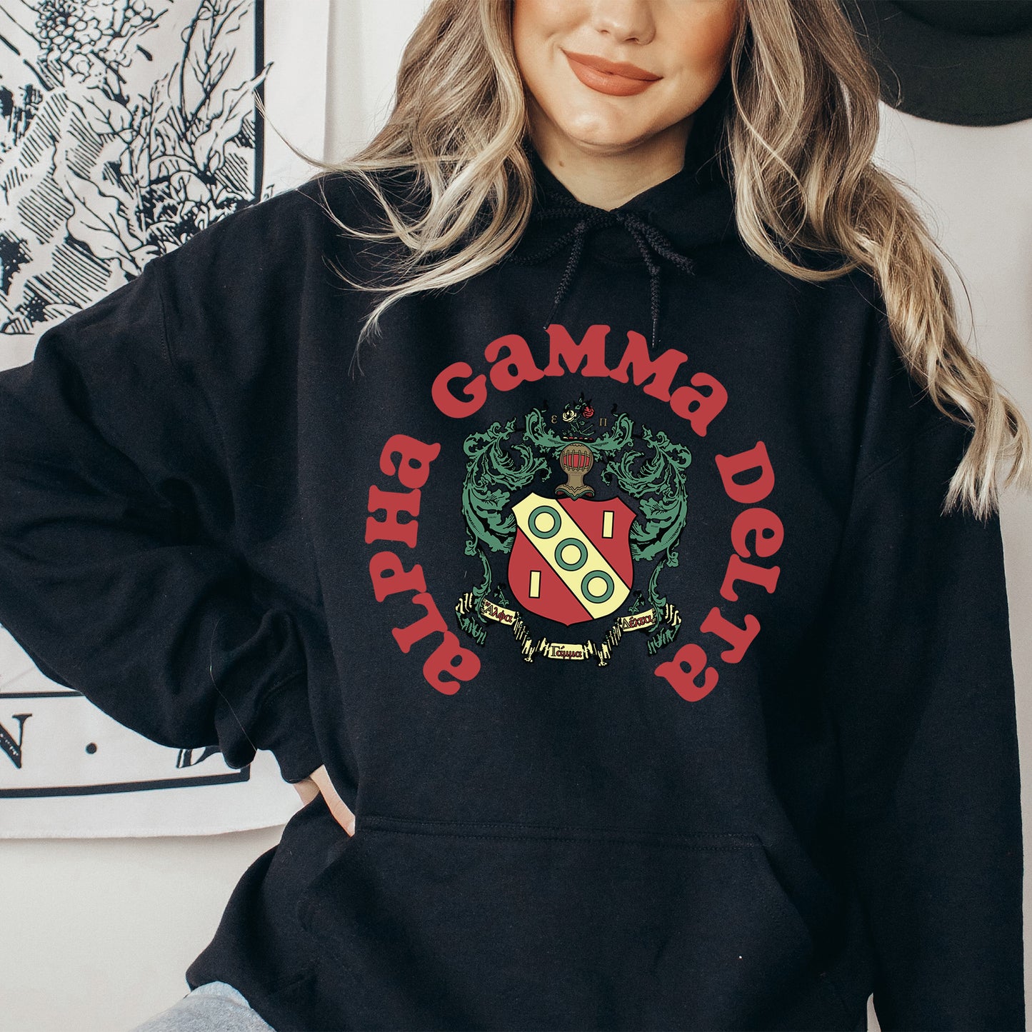 a woman wearing a black hoodie with a red and yellow logo