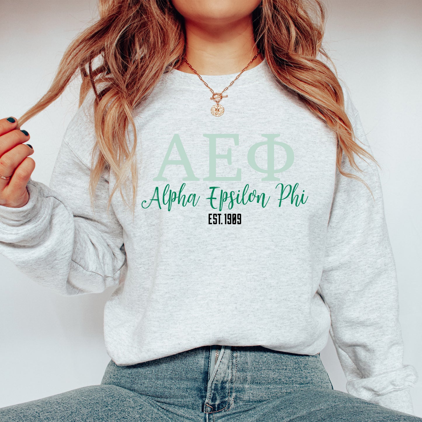 a woman wearing a sweatshirt that says aphrra explore piu