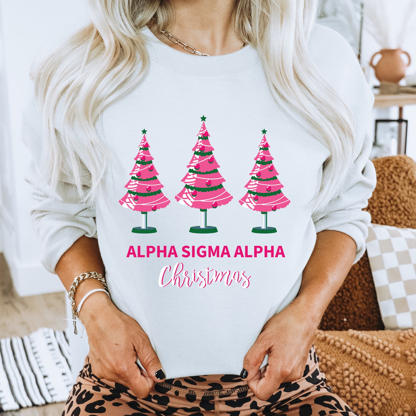 a woman wearing a sweatshirt with three christmas trees on it