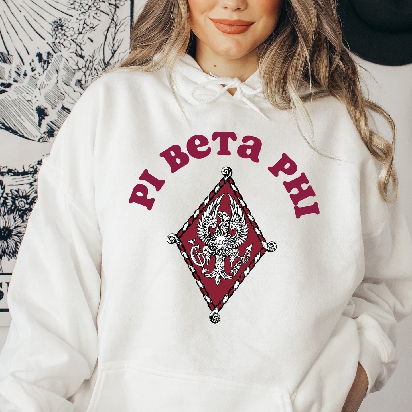 a woman wearing a white hoodie with a red dragon on it