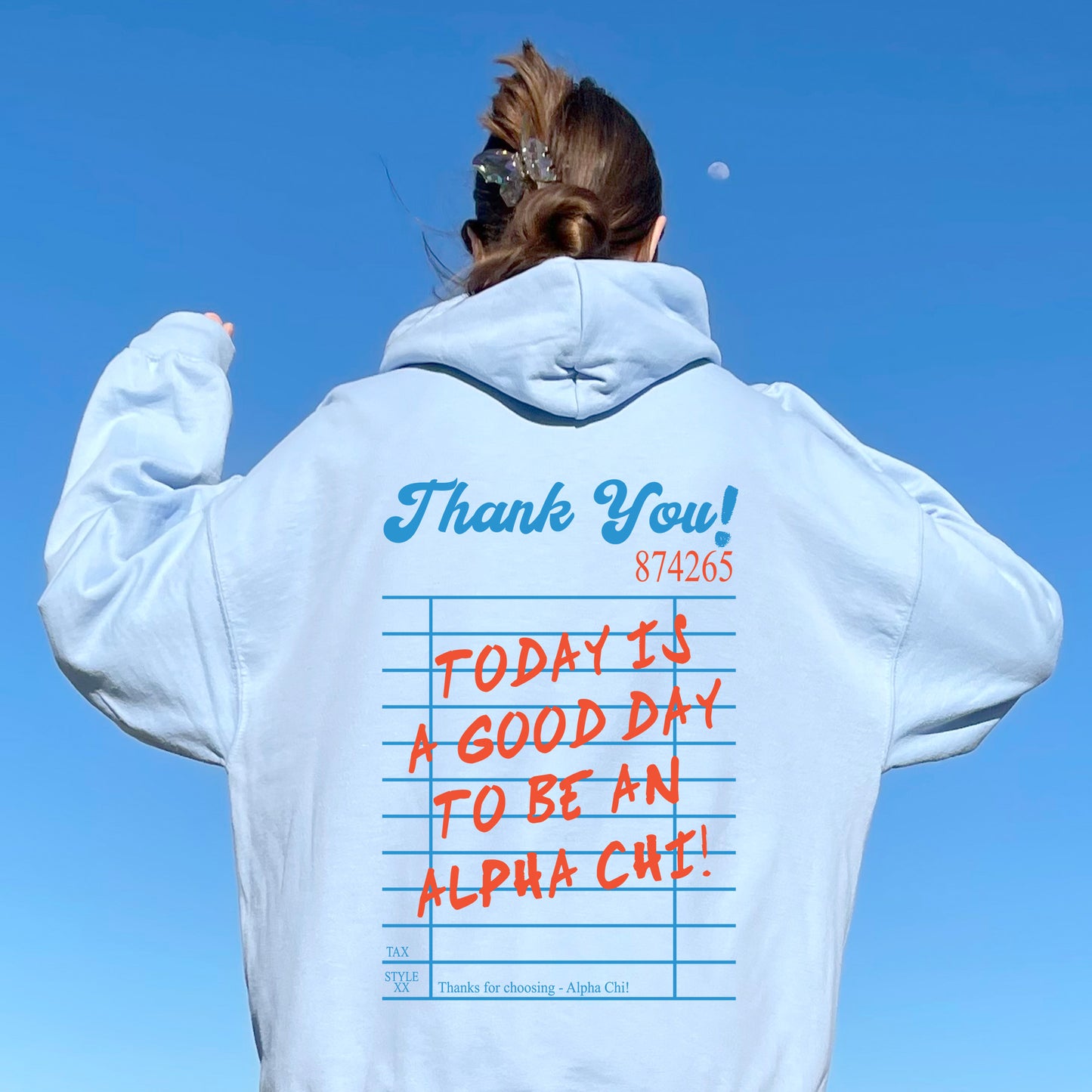 a woman wearing a white hoodie with writing on it