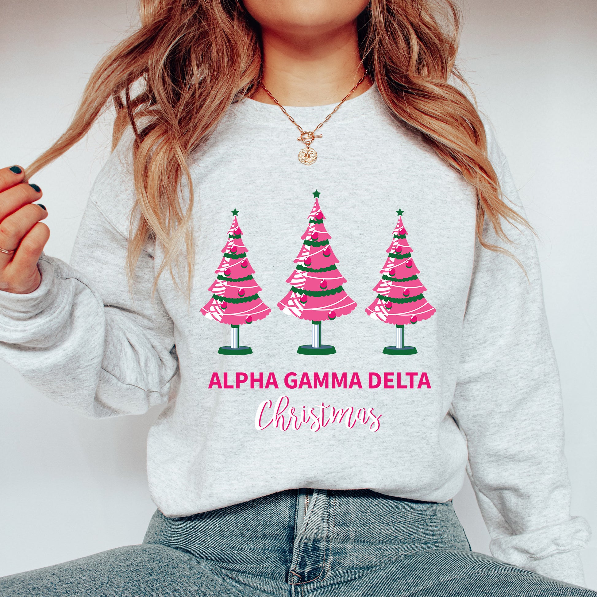 a woman wearing a sweatshirt with christmas trees on it