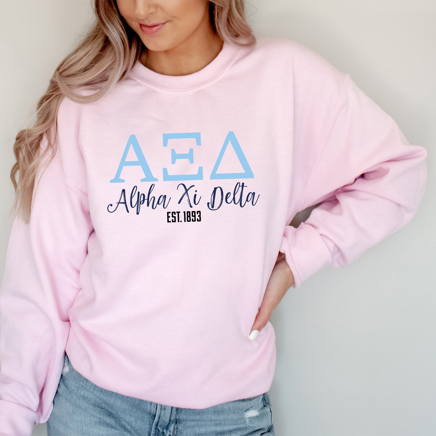 a woman wearing a pink aea sweatshirt
