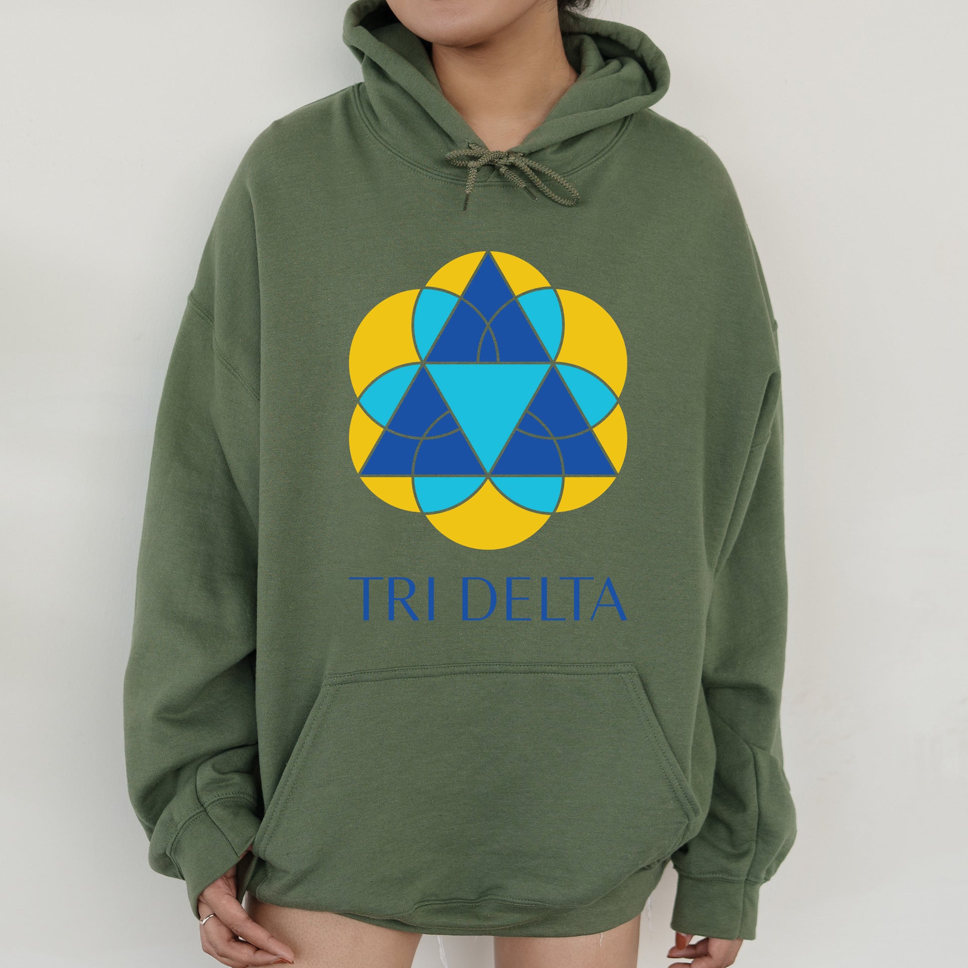 a person wearing a green hoodie with a blue triangle on it