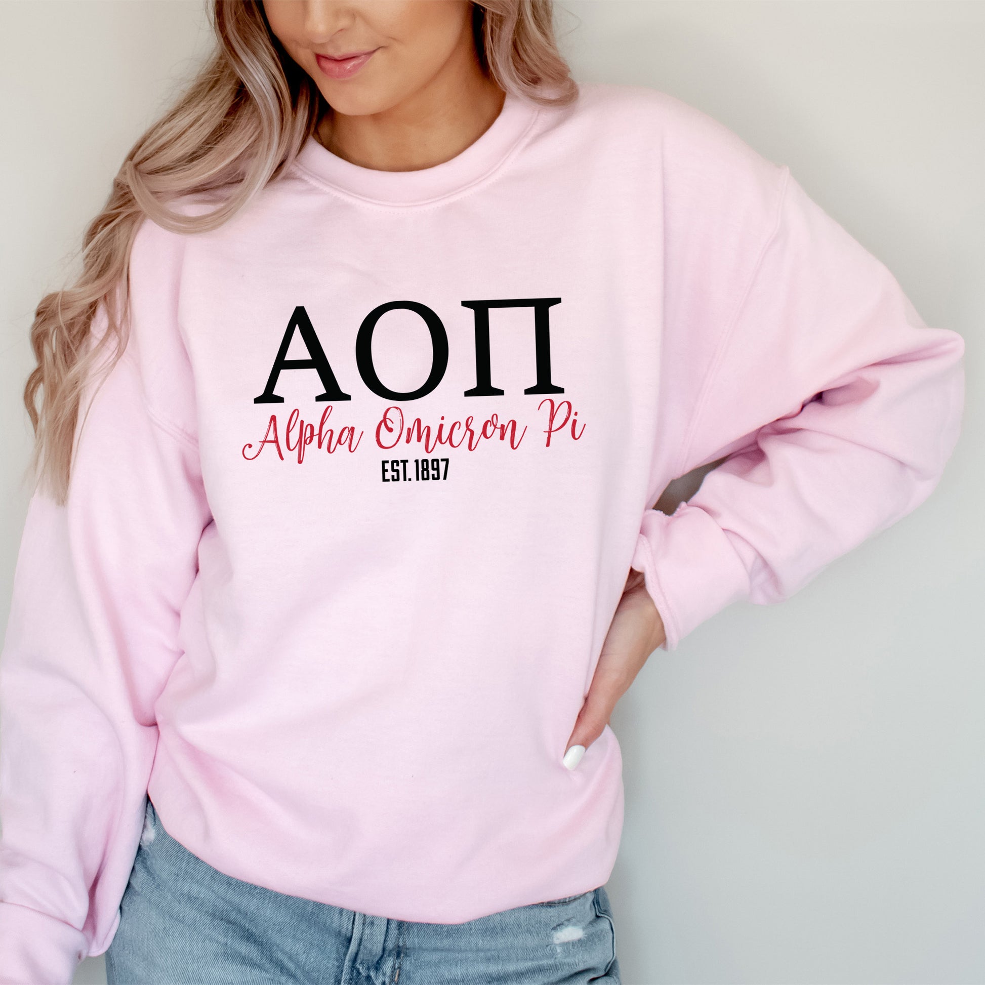 a woman wearing a pink sweatshirt with the word aoi on it