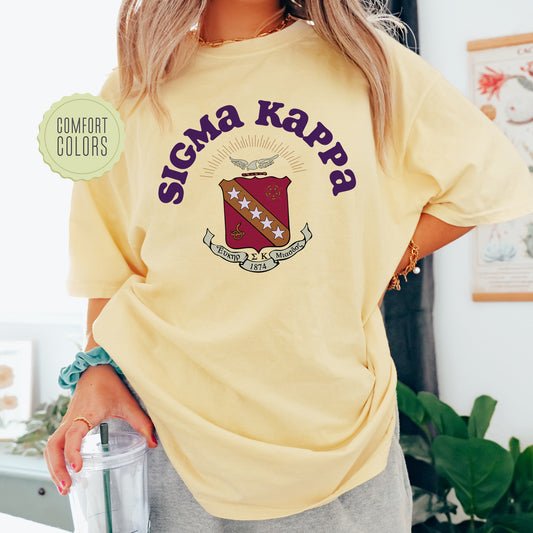 a woman in a yellow shirt is holding a drink