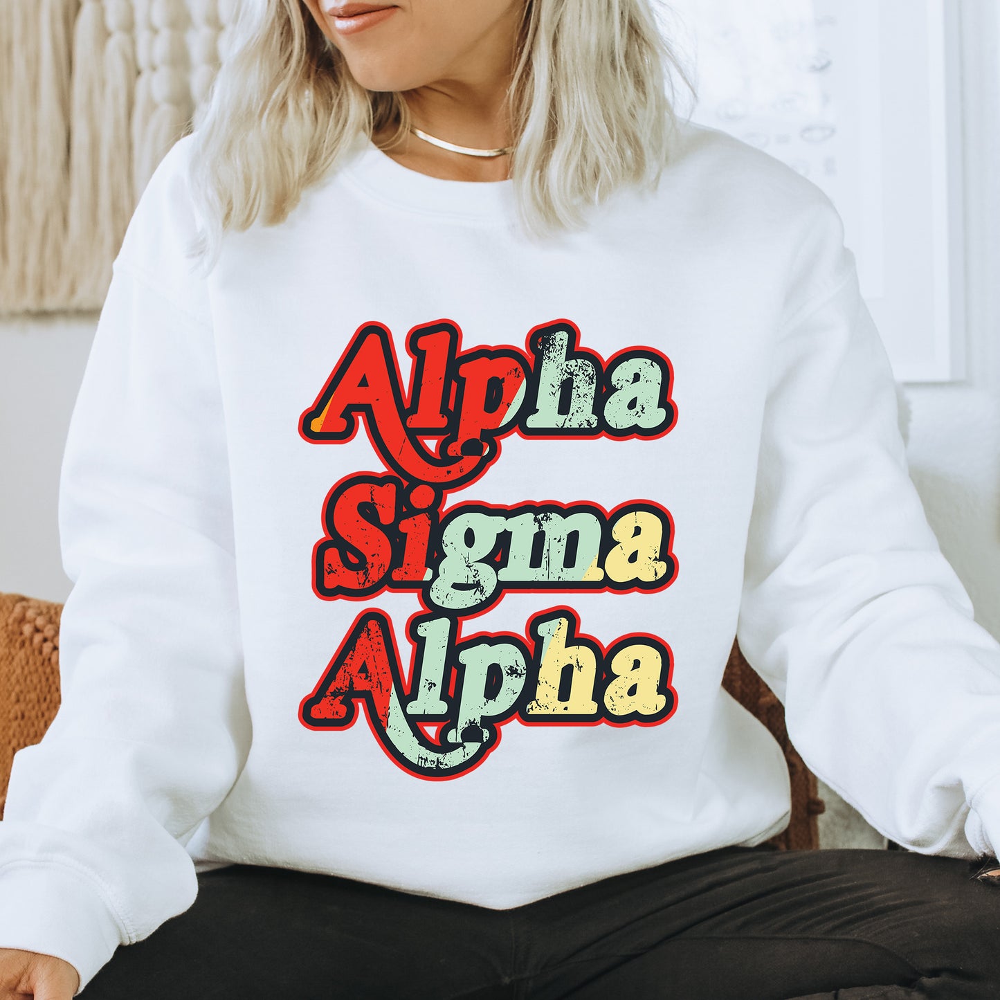 a woman sitting on a chair wearing a white sweatshirt