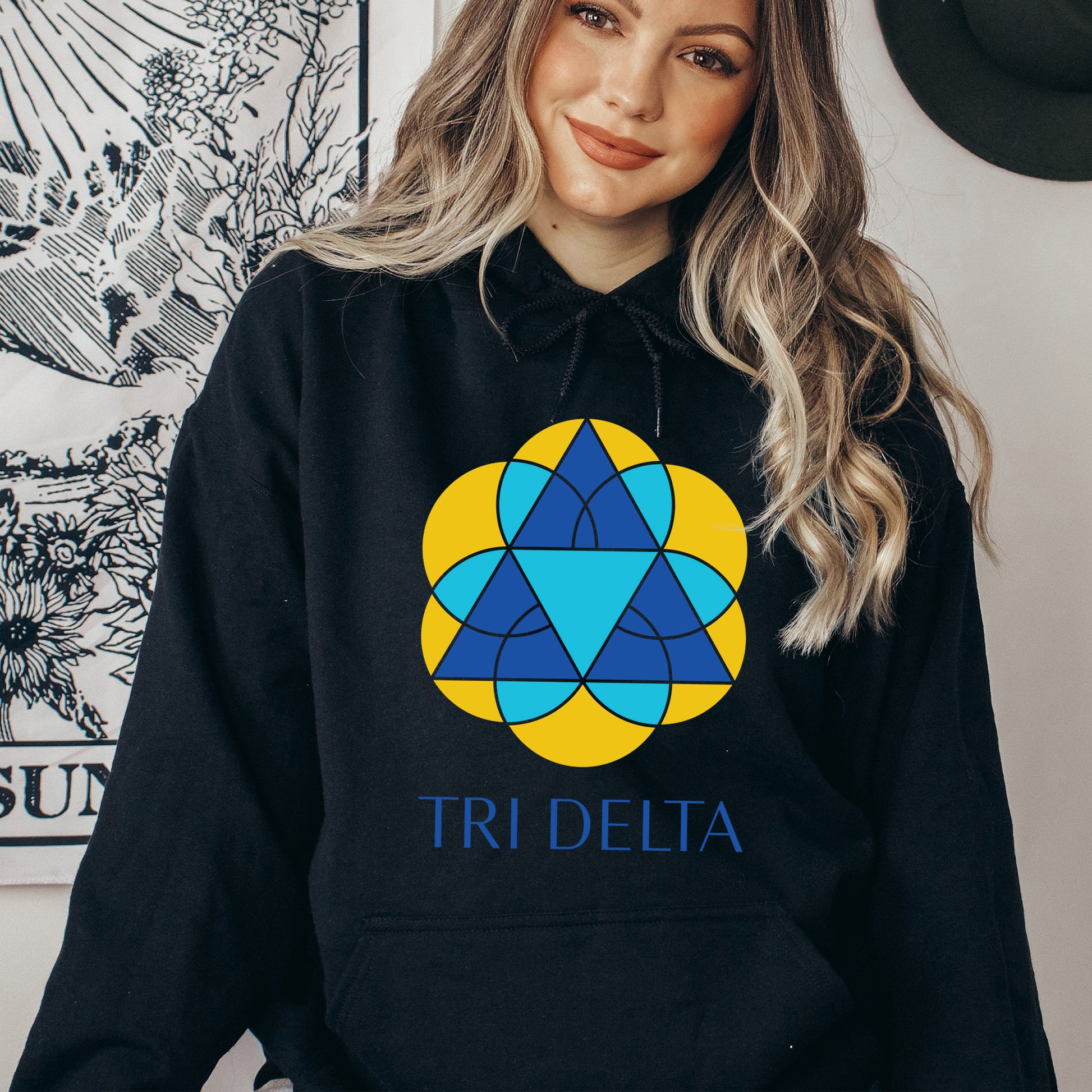 a woman wearing a black tri delta hoodie