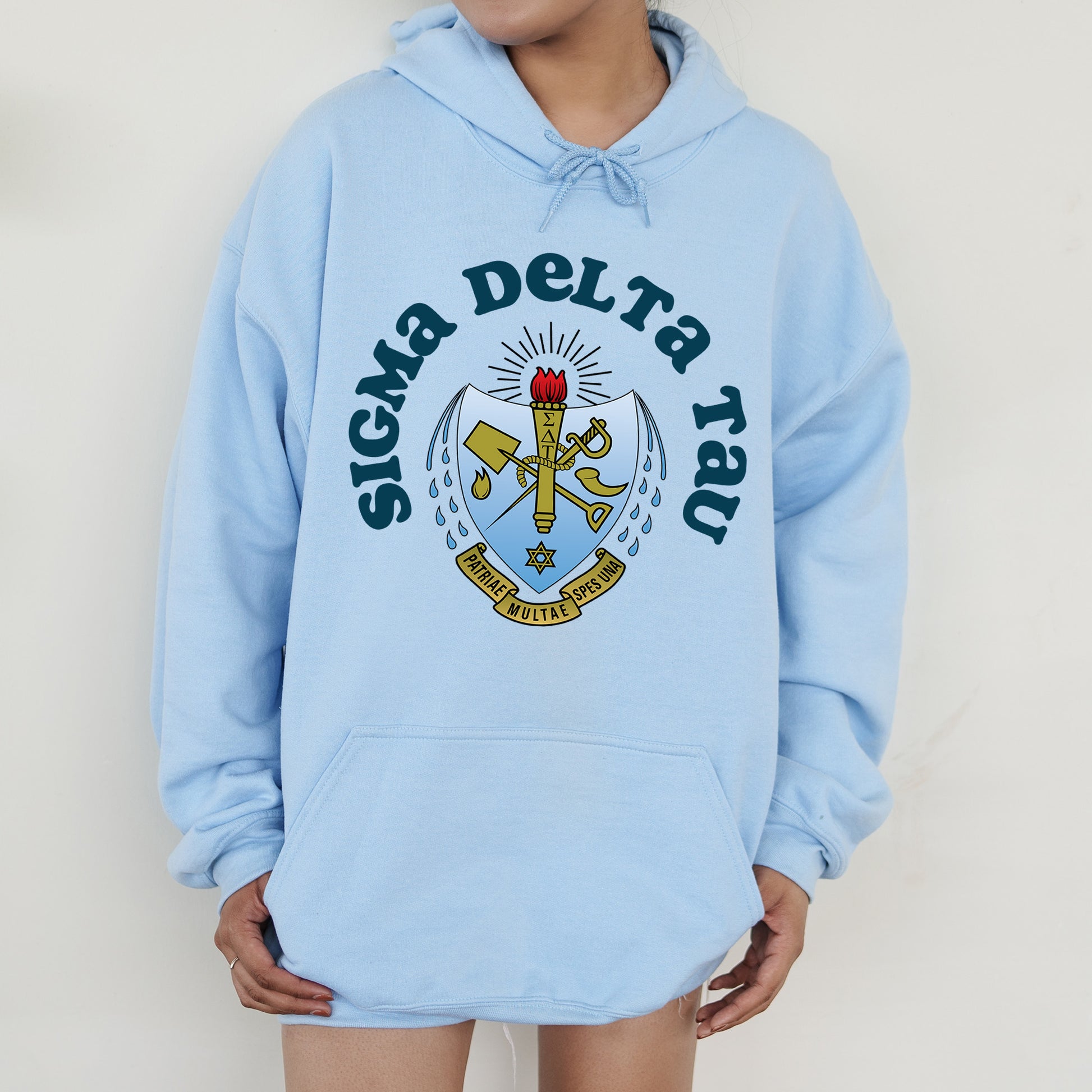 a person wearing a blue hoodie with a crest on it