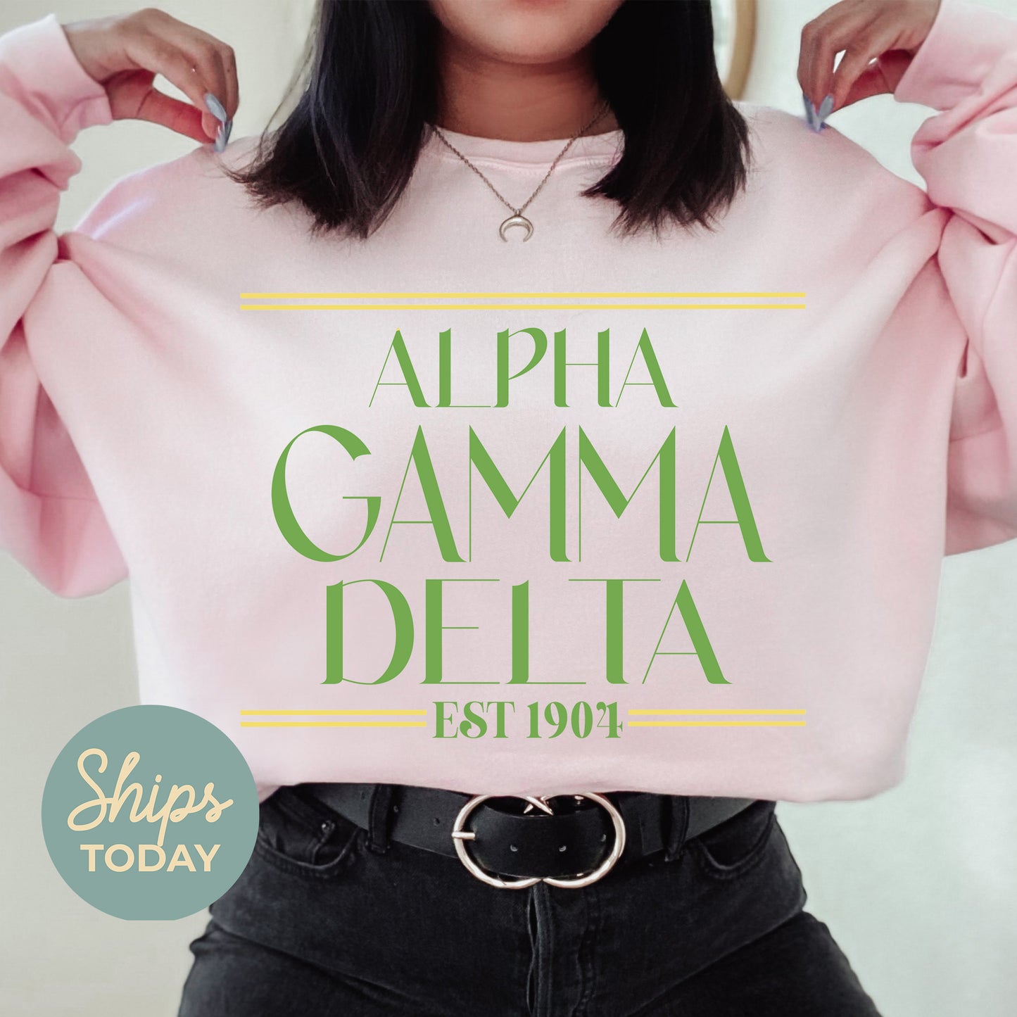 a woman holding up a pink sweatshirt with the words, alpha gama delta est