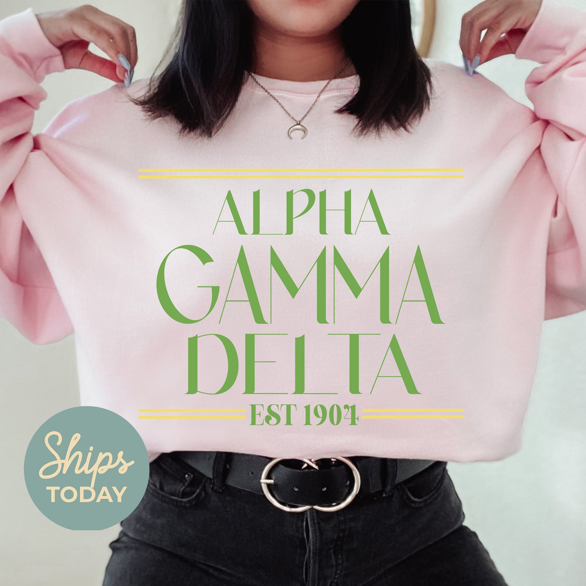a woman holding up a pink sweatshirt with the words, alpha gama delta est