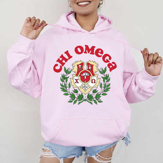a woman wearing a pink hoodie with a crest on it