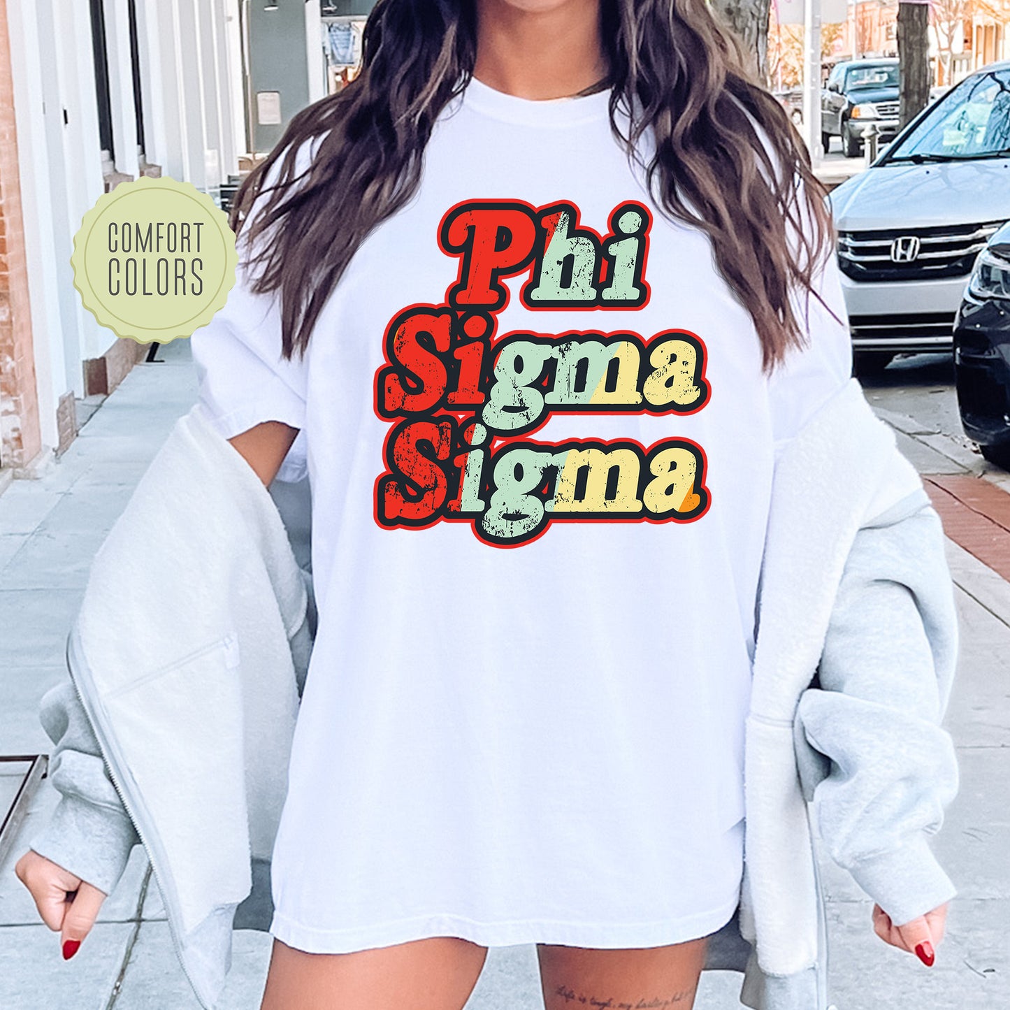 a woman wearing a white shirt with the words phi sigma sigma