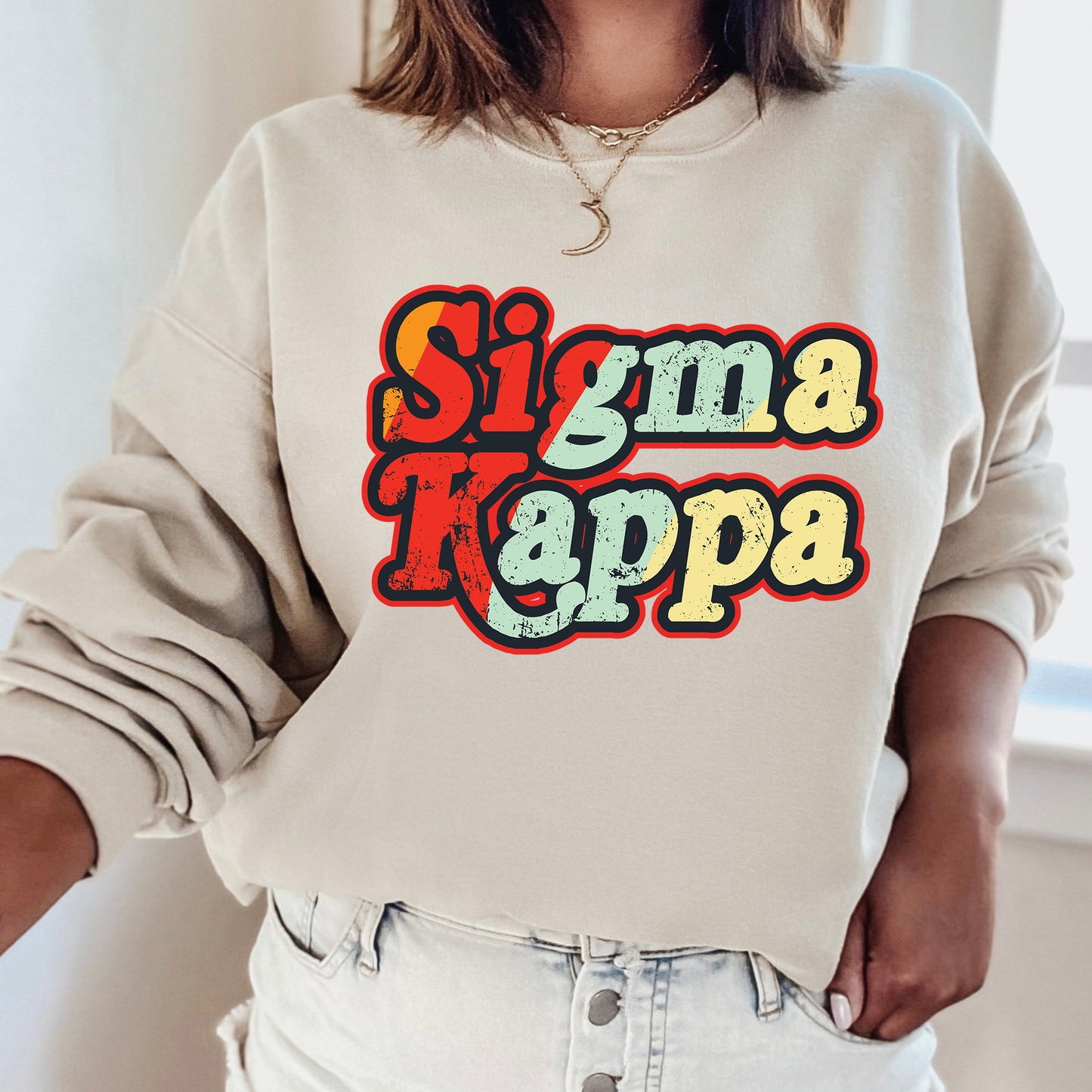 a woman wearing a sweatshirt that says stigma kappa