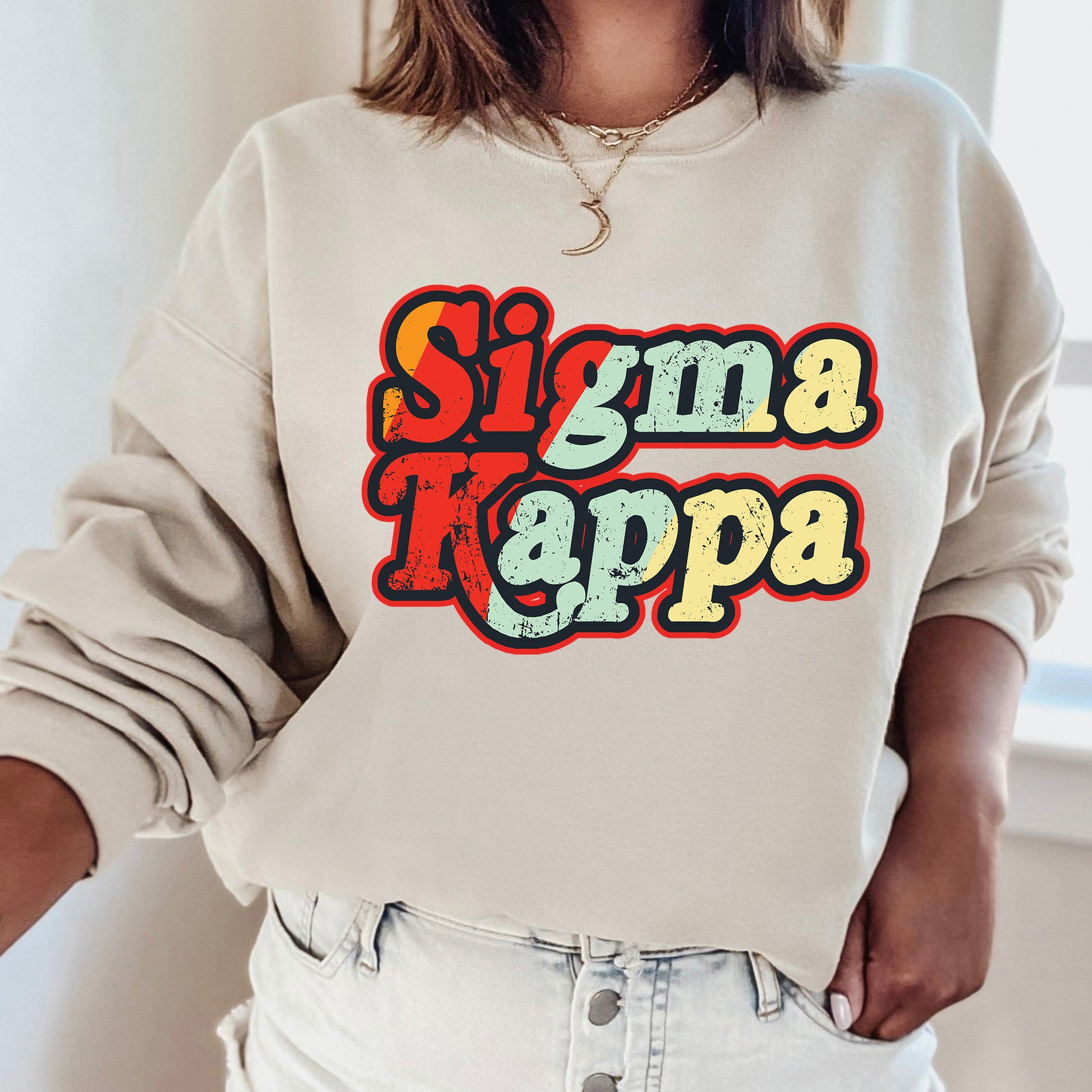 a woman wearing a sweatshirt that says stigma kappa