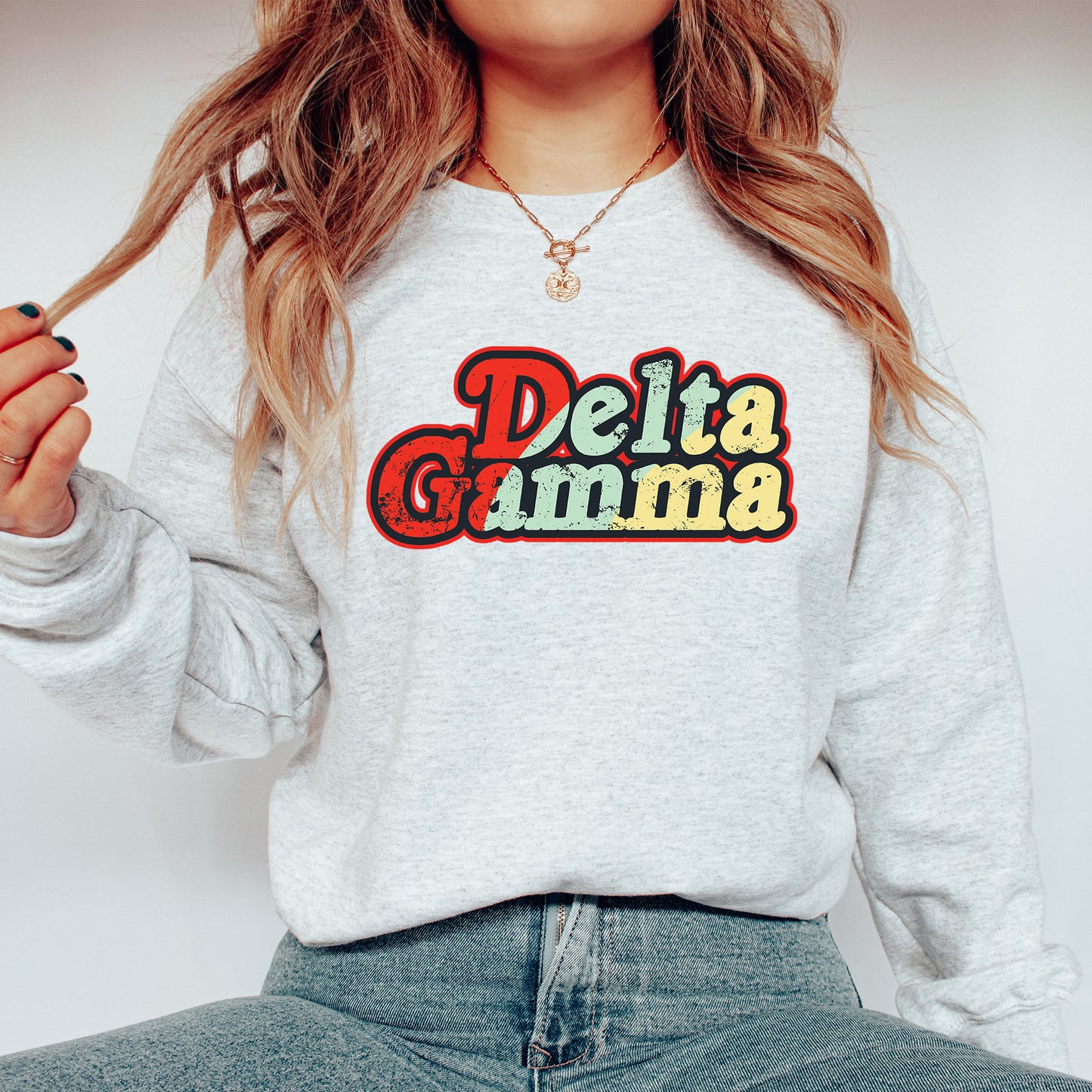 a woman wearing a sweatshirt that says delta gumma