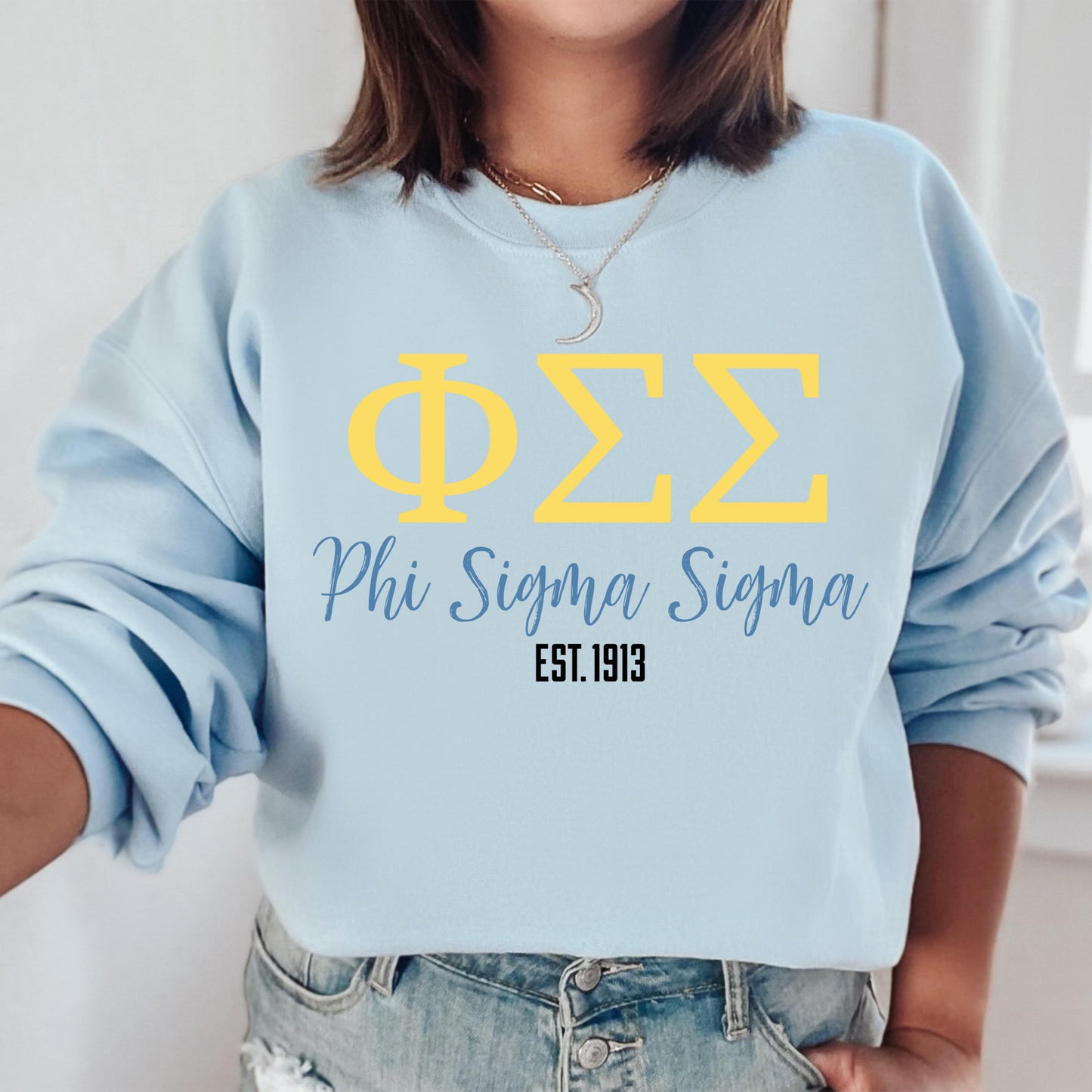 a woman wearing a blue phi sigma sweatshirt