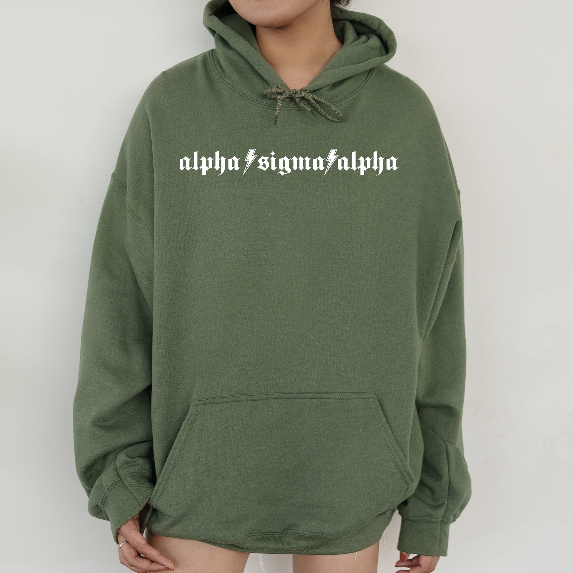 a person wearing a green hoodie with the words alphonsima alphon