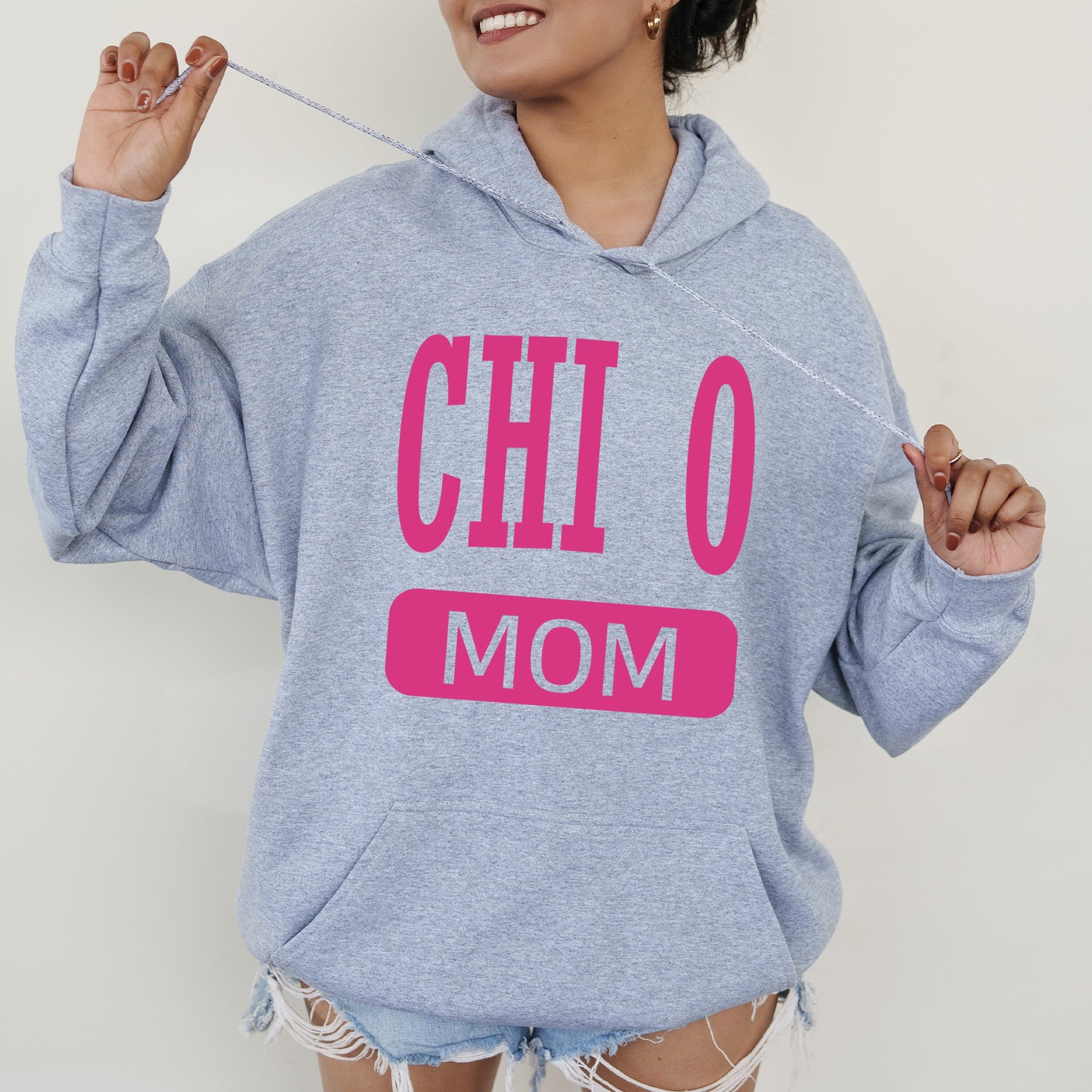 a woman wearing a hoodie that says chio mom
