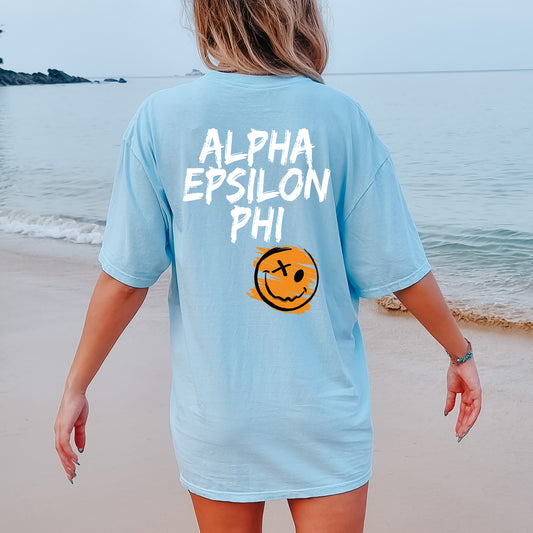 a woman walking on the beach with a smile on her shirt