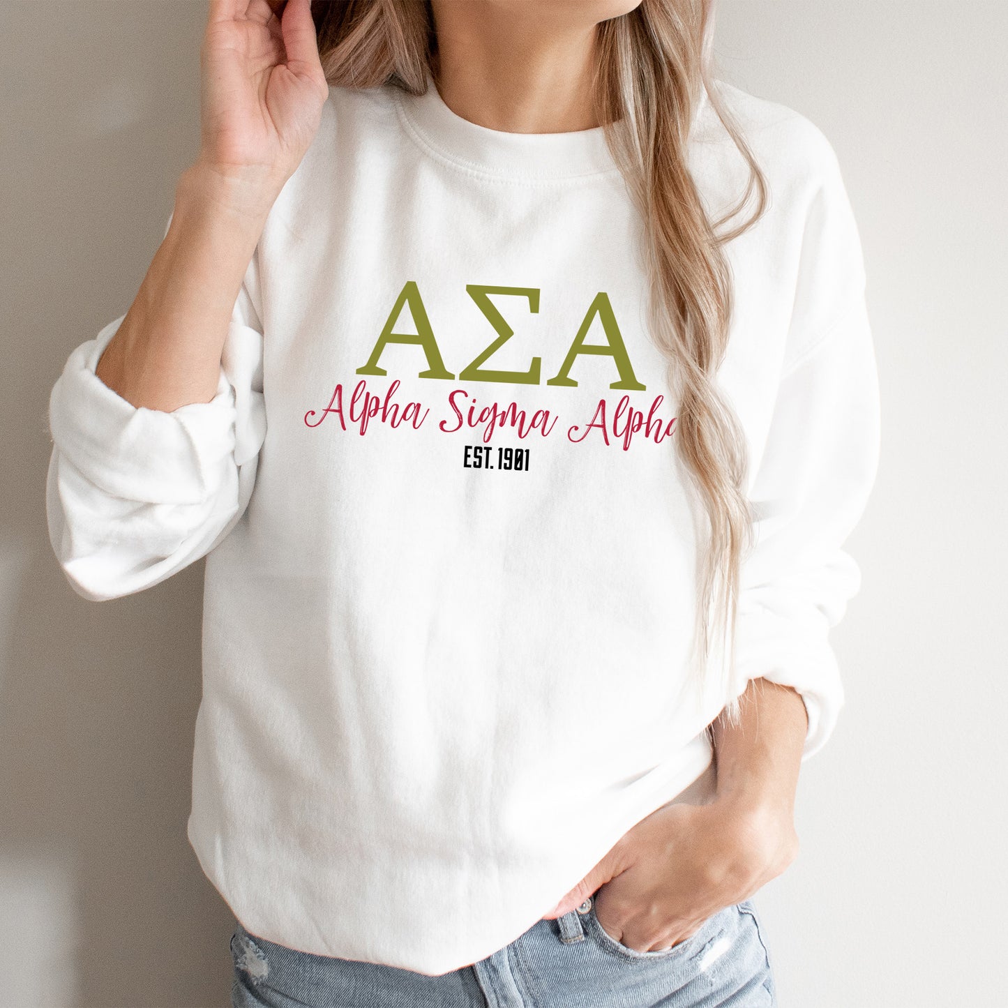 a woman wearing a white sweatshirt with the word aza on it