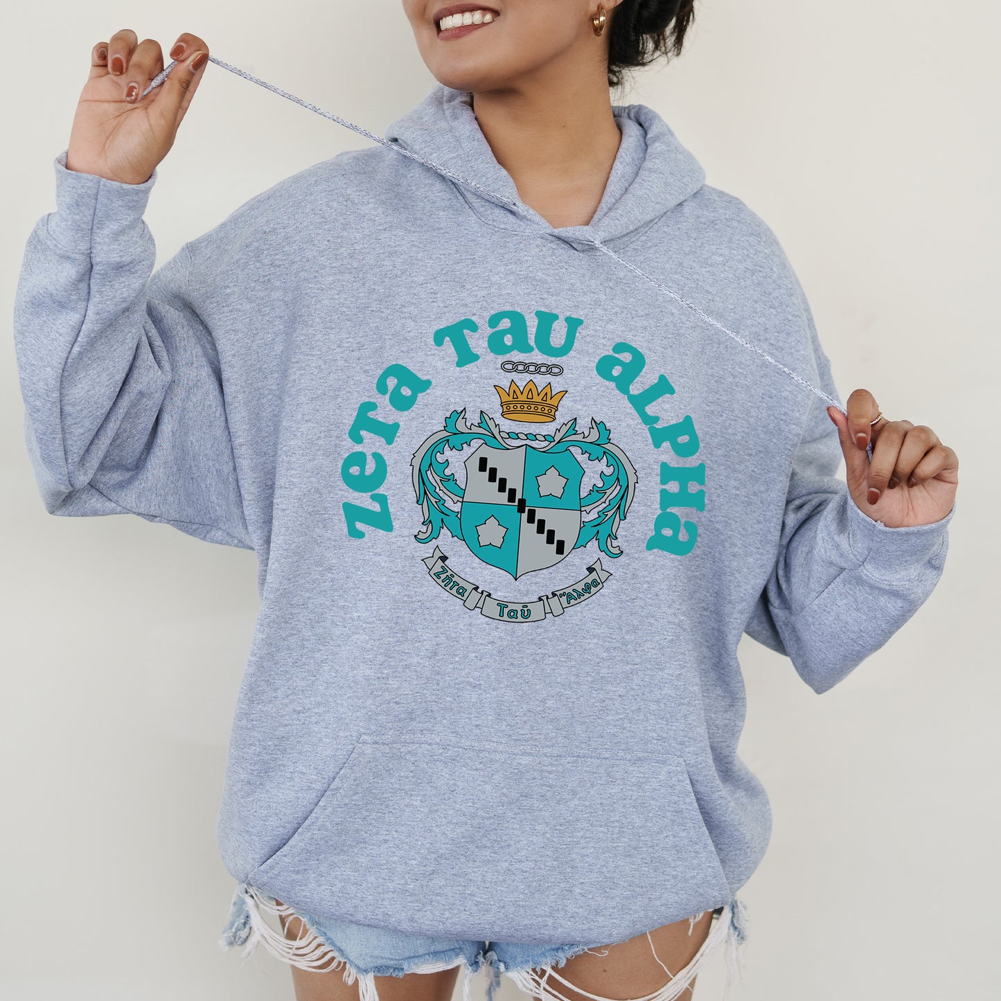 a woman in a blue hoodie holding a toothbrush