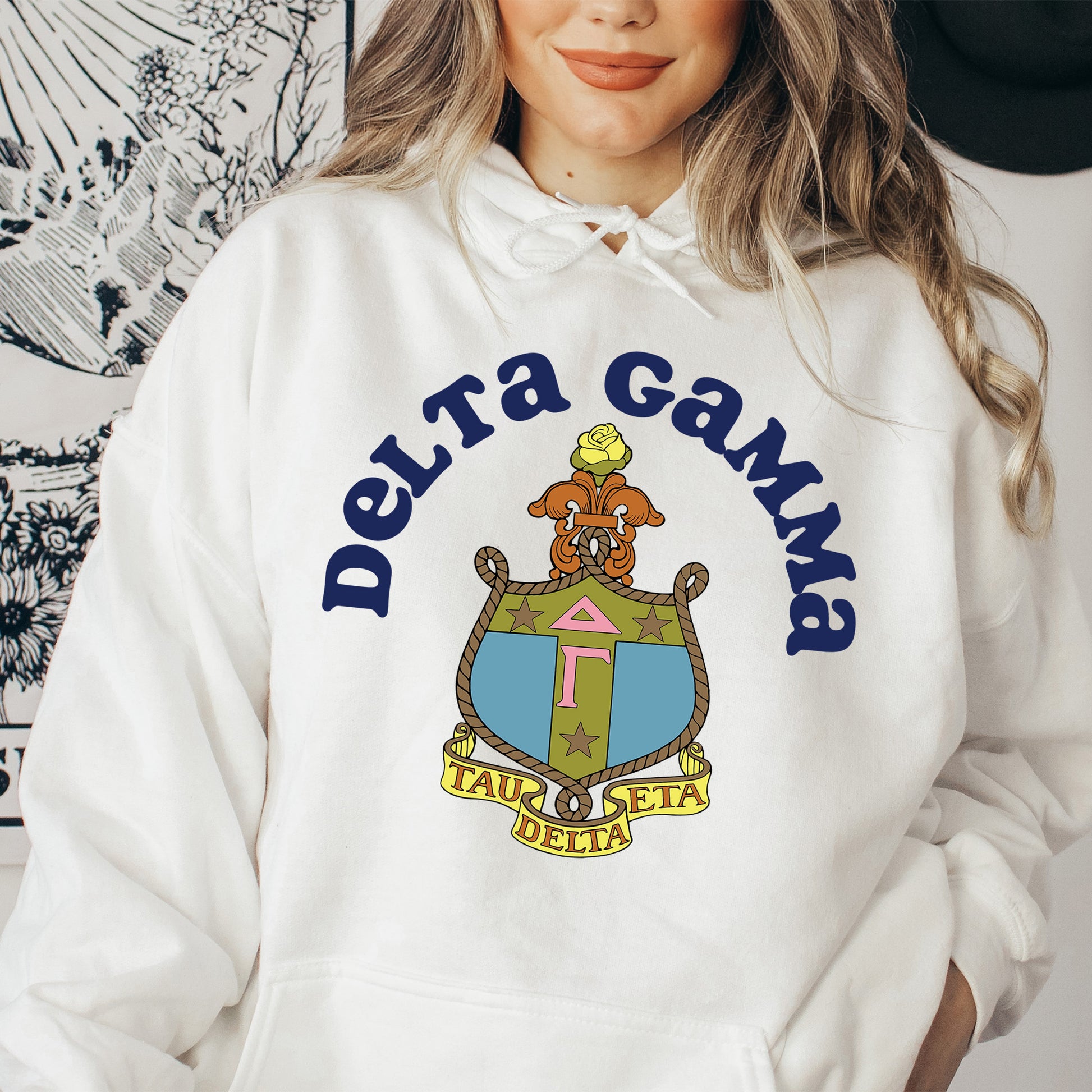 a woman wearing a white hoodie with a picture of a dog on it