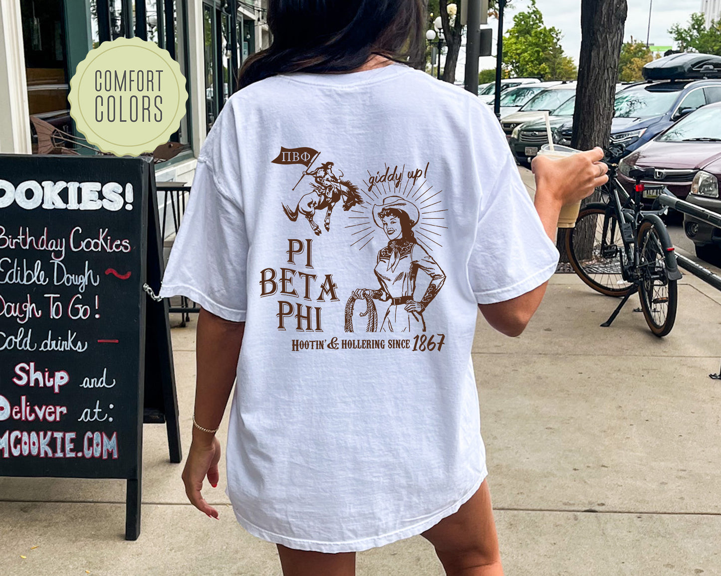 a woman walking down a sidewalk while wearing a white shirt