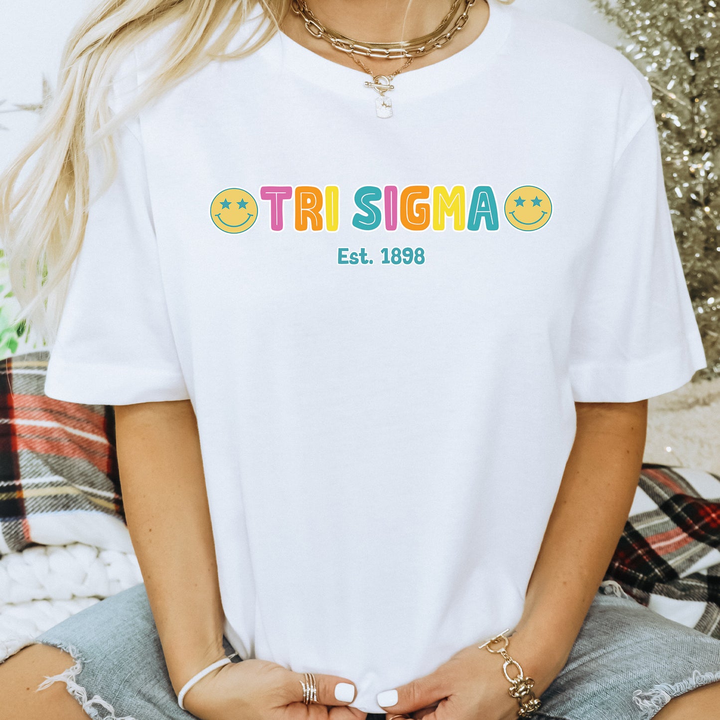 a woman wearing a white tshirt that says trisima