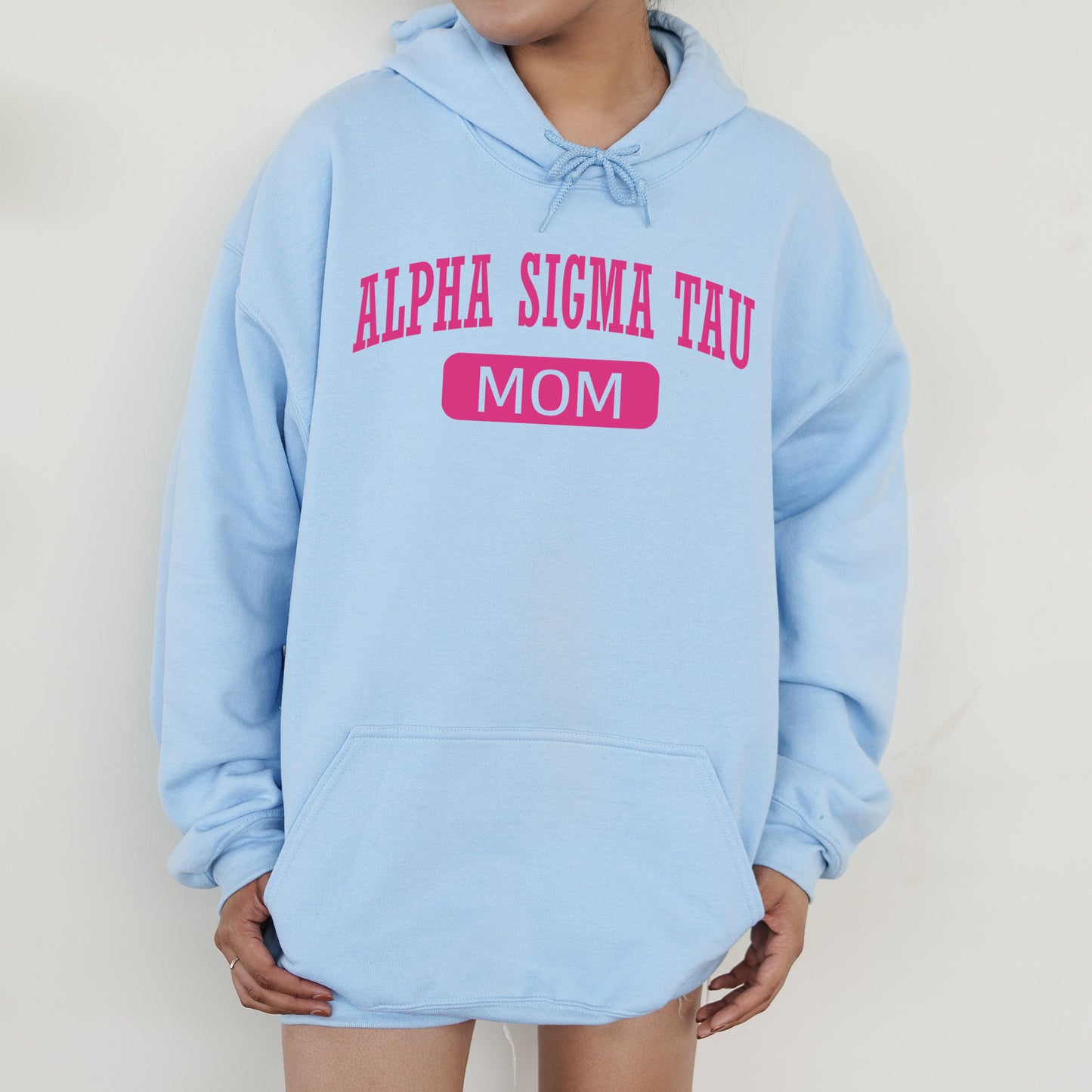 a woman wearing a blue hoodie that says,'aloha stigma tau