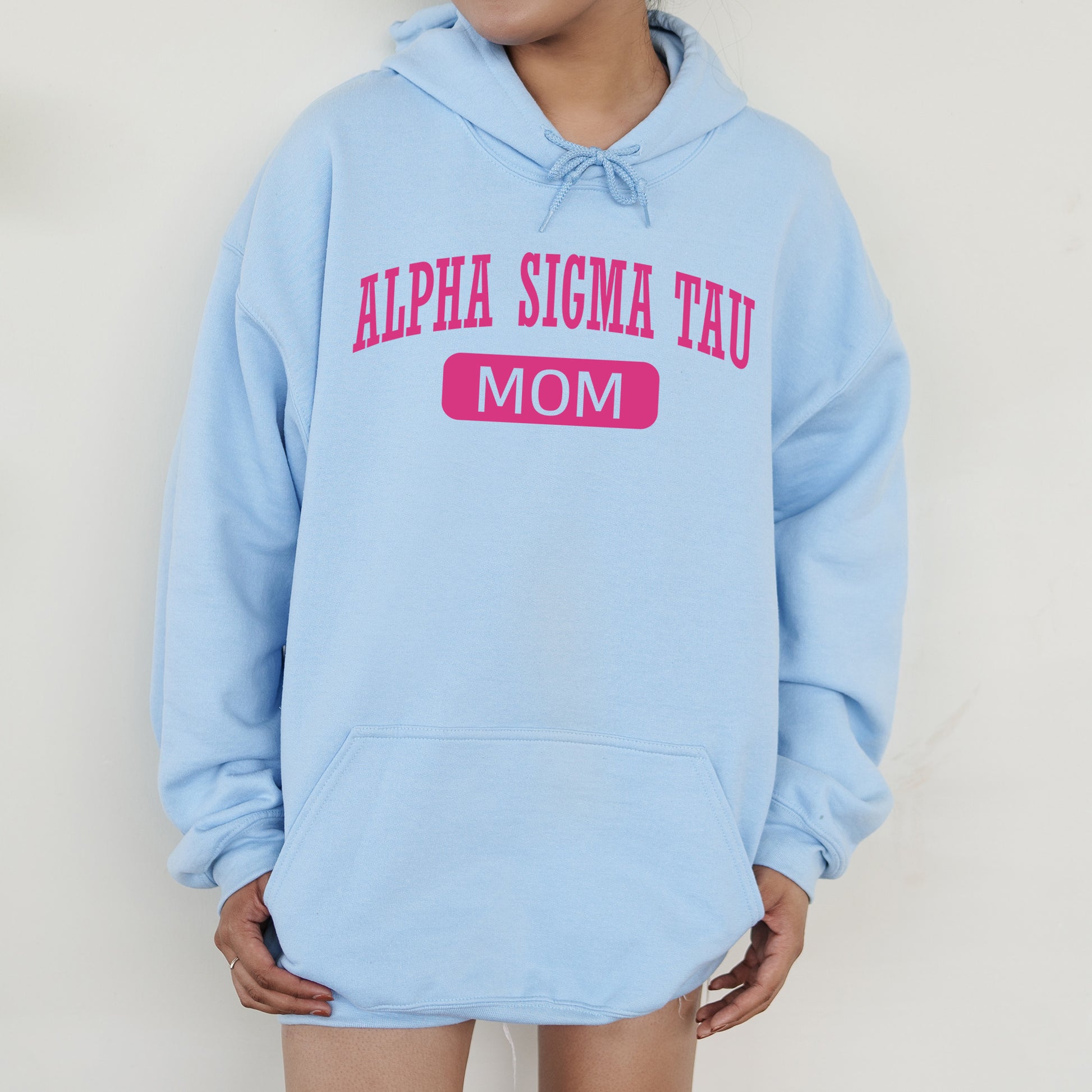 a woman wearing a blue hoodie that says,'aloha stigma tau