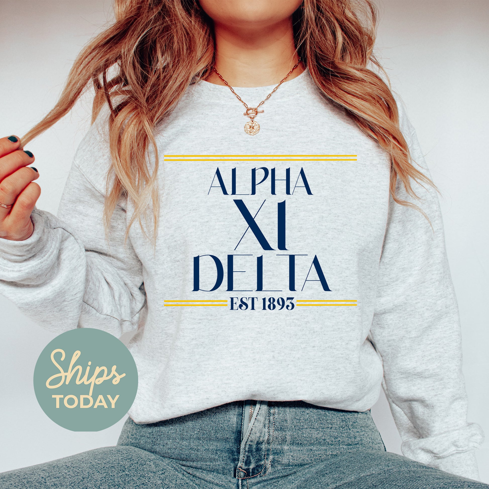 a woman wearing a sweatshirt with the words alpha al delta printed on it