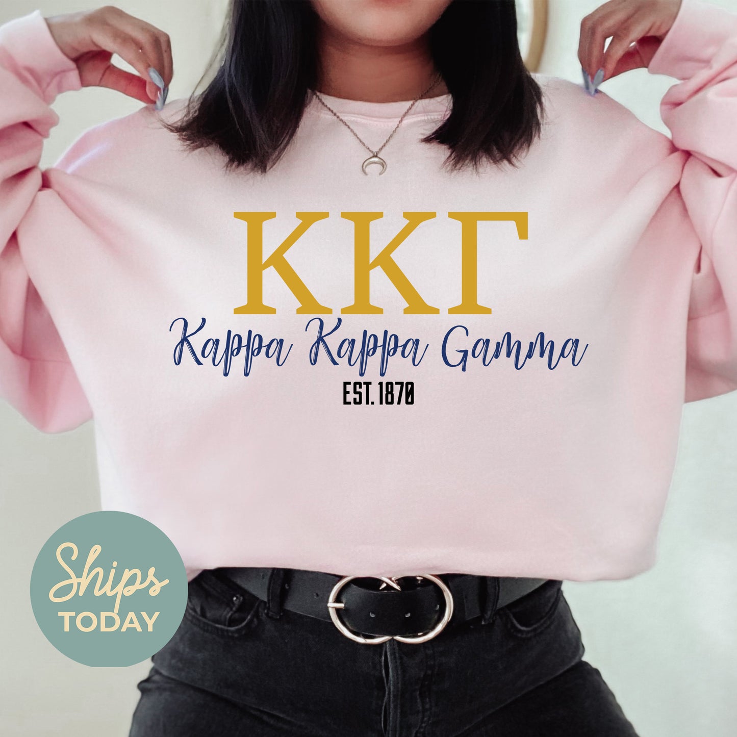 a woman wearing a pink sweatshirt with the kkt logo on it