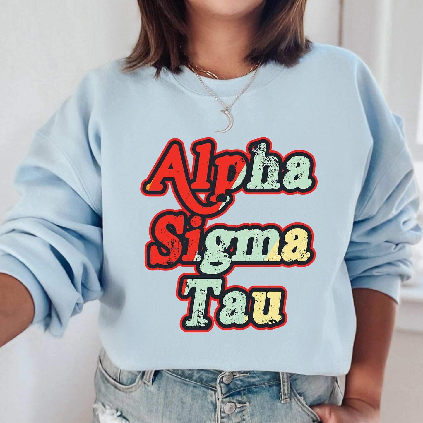 a woman wearing a blue sweatshirt with the words aloha sigma ta