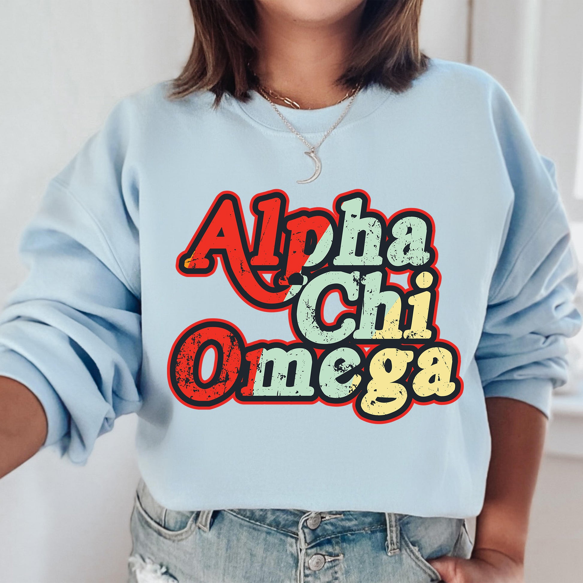 a woman wearing a blue sweatshirt with the word'apha chi omega'printed