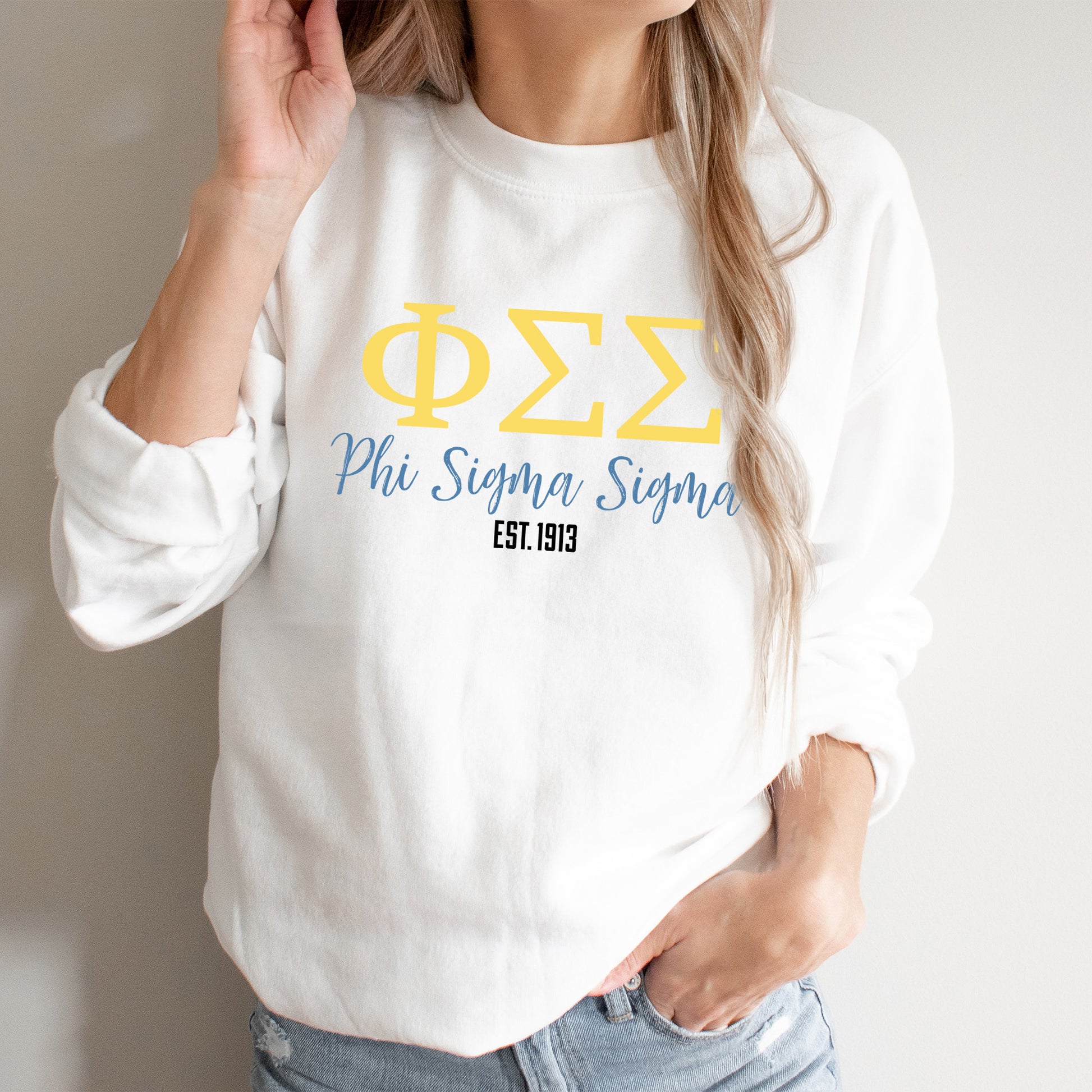 a woman wearing a white sweatshirt with greek letters on it
