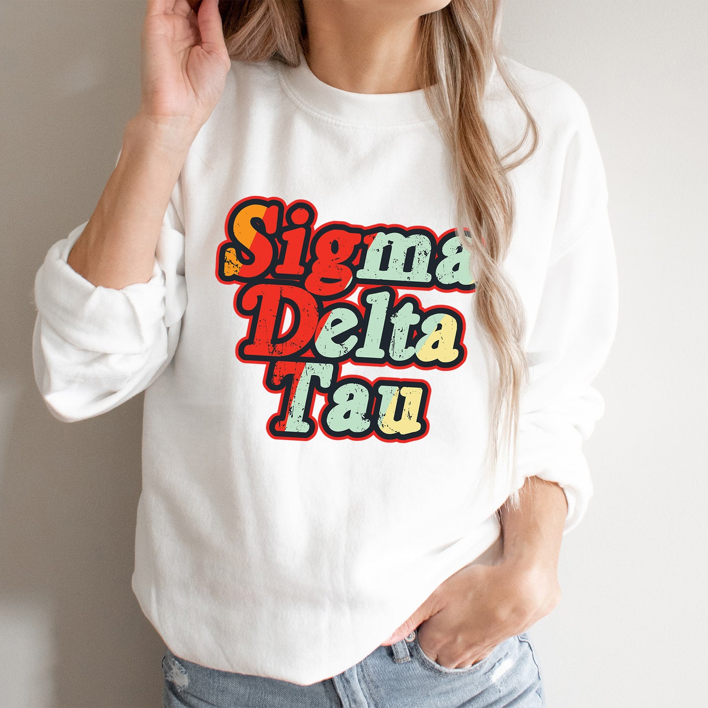 a woman wearing a white sweatshirt that says singma delta tau