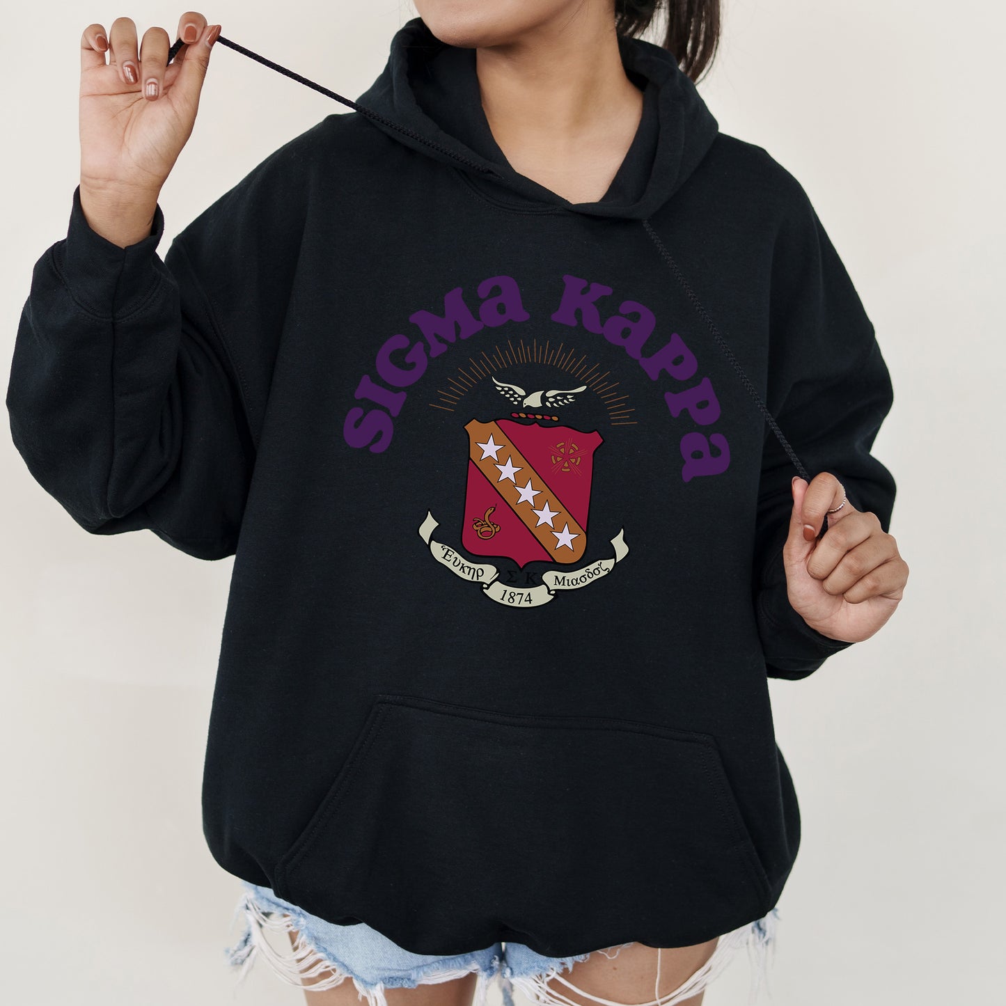 a woman in a black hoodie holding a toothbrush