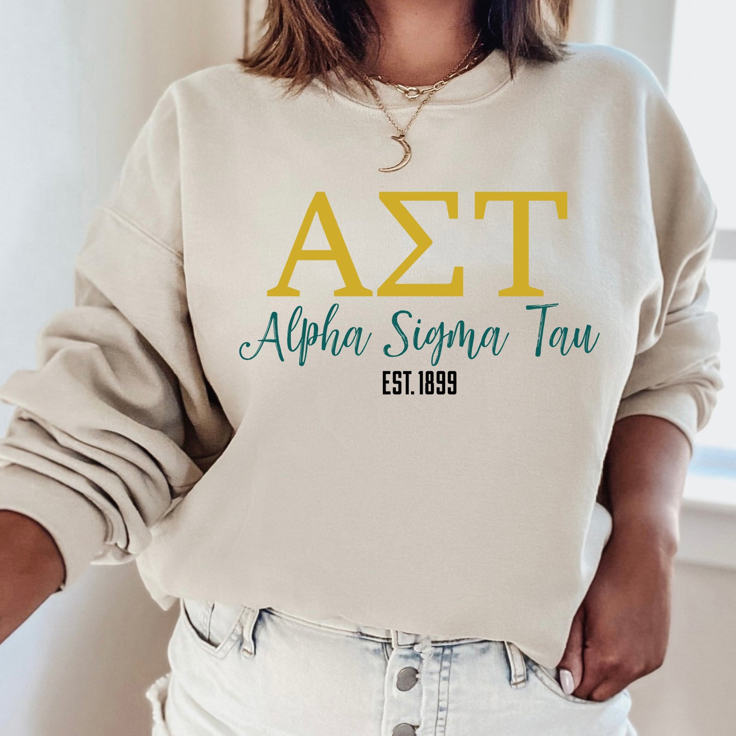 a woman wearing a white sweatshirt with the letters azt on it