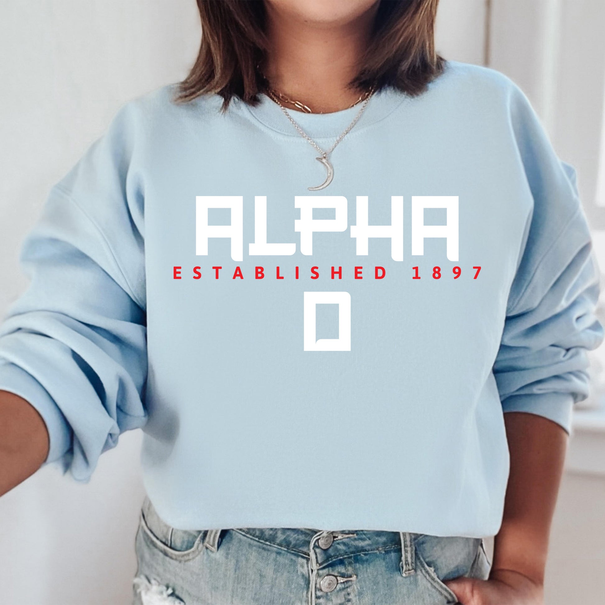 a woman wearing a blue sweatshirt with the word alphabet printed on it