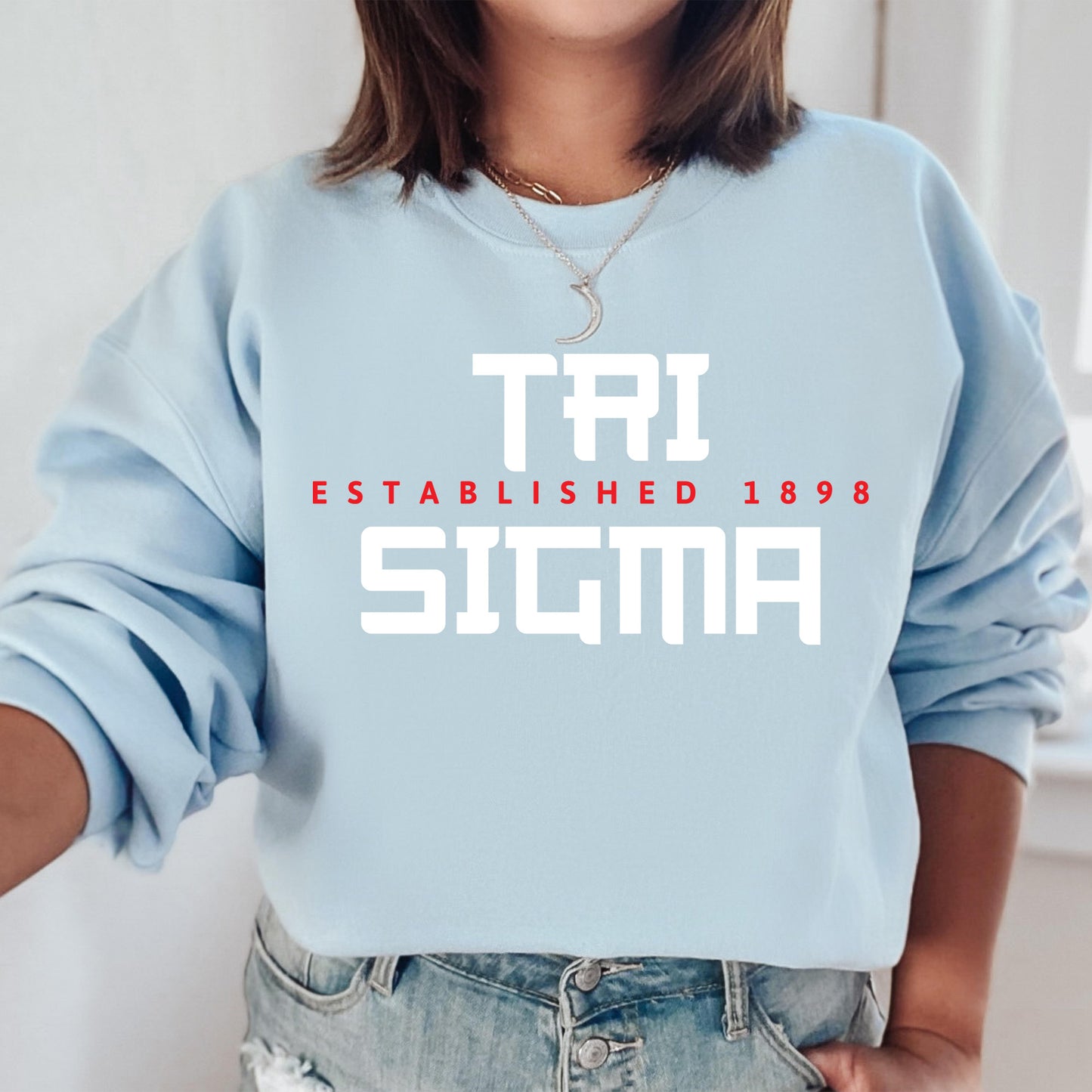 a woman wearing a blue sweatshirt with the words tri established 1989