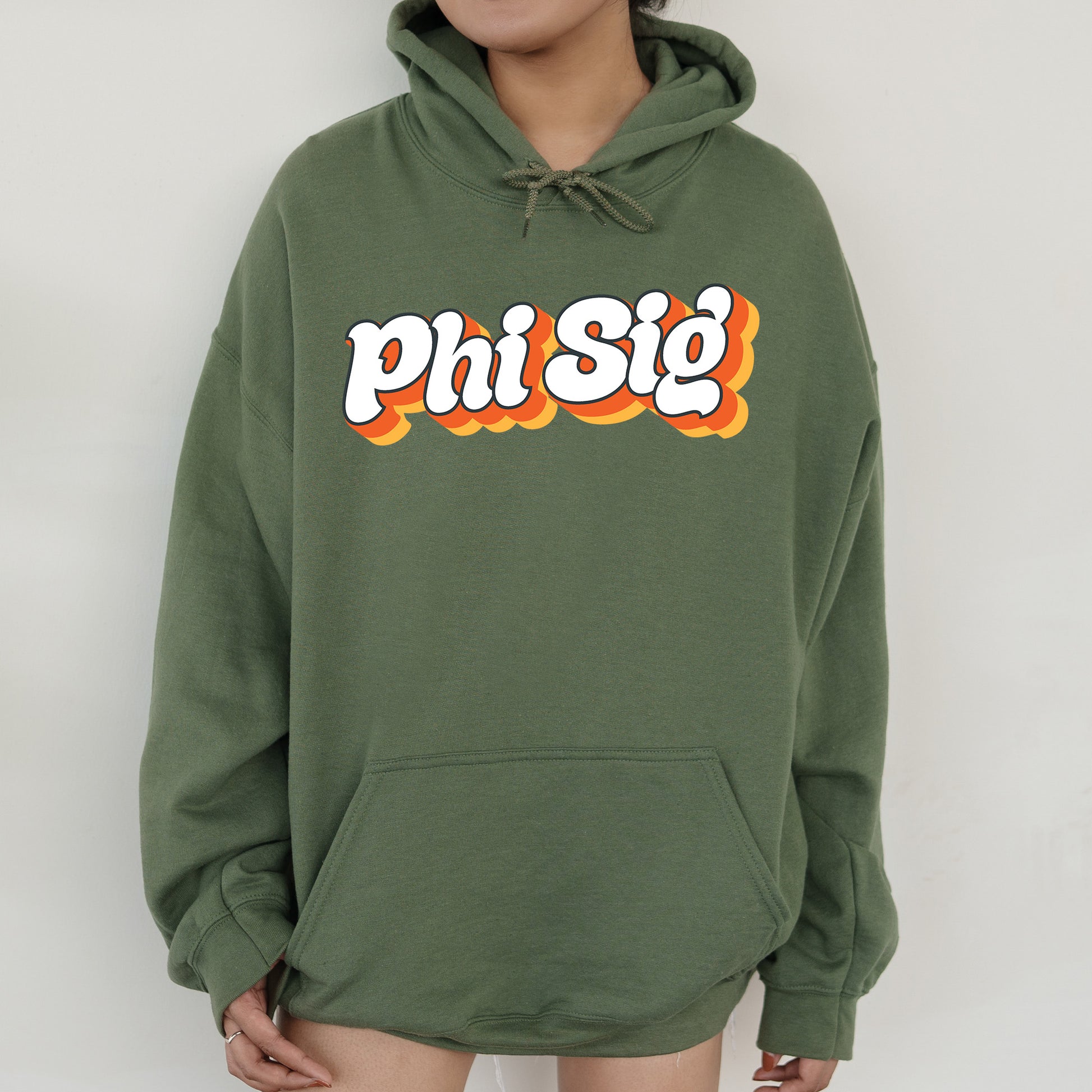 a person wearing a green hoodie with the word phi sig printed on it