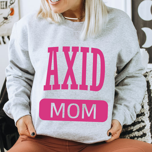 a woman wearing a sweatshirt that says axd mom