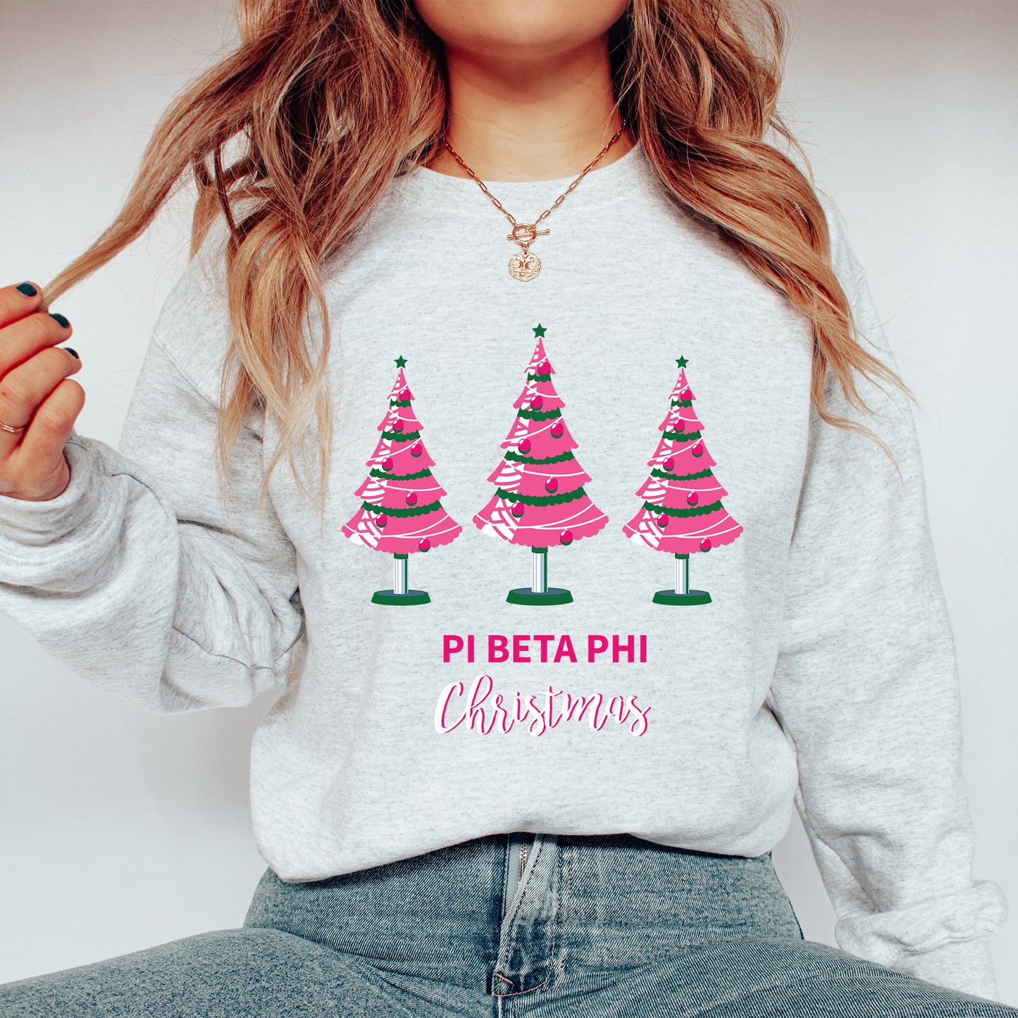 a woman wearing a sweatshirt with christmas trees on it