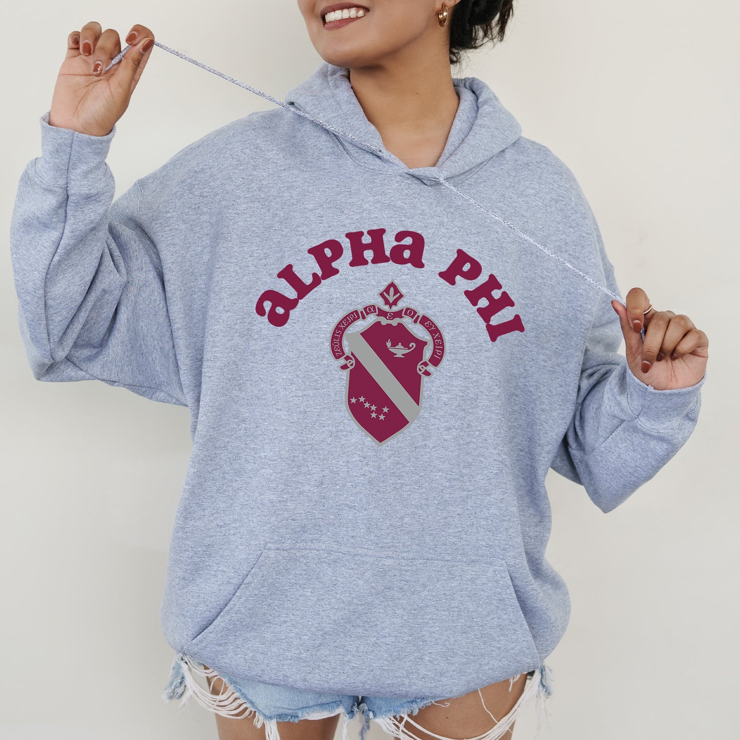 a woman in a blue hoodie holding a toothbrush