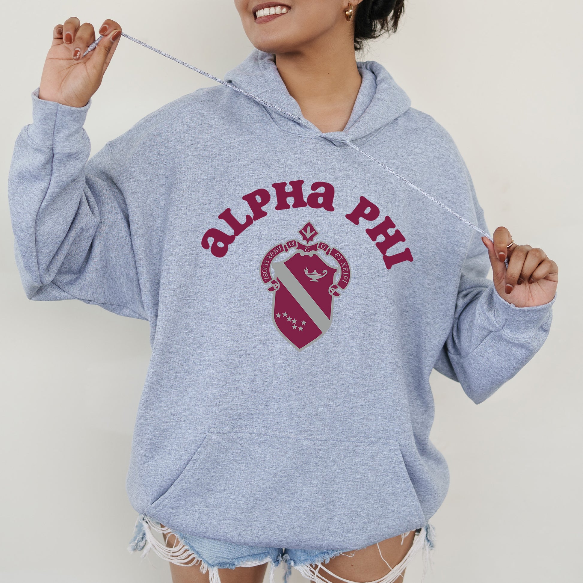 a woman in a blue hoodie holding a toothbrush