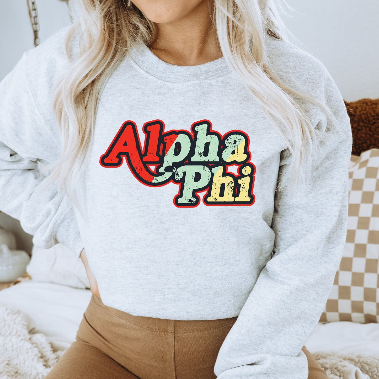 a woman wearing a sweatshirt that says aloha phi